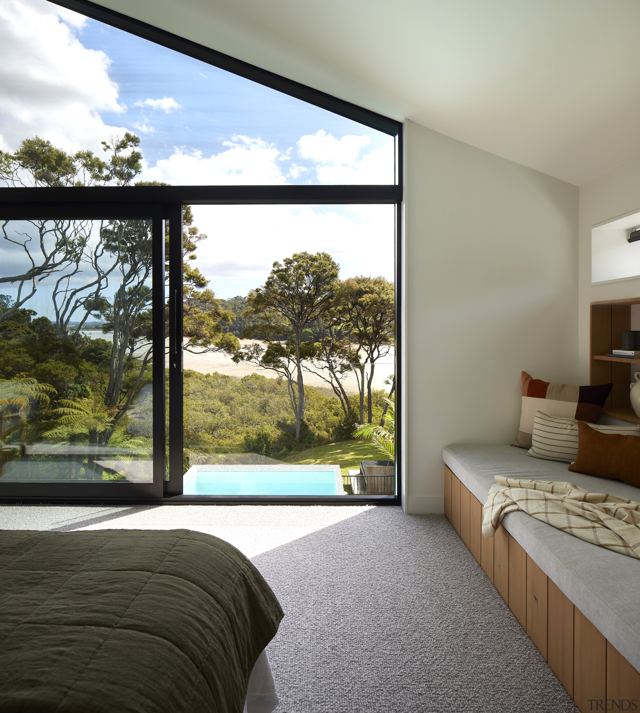 Master bedroom with a wall of windows that 