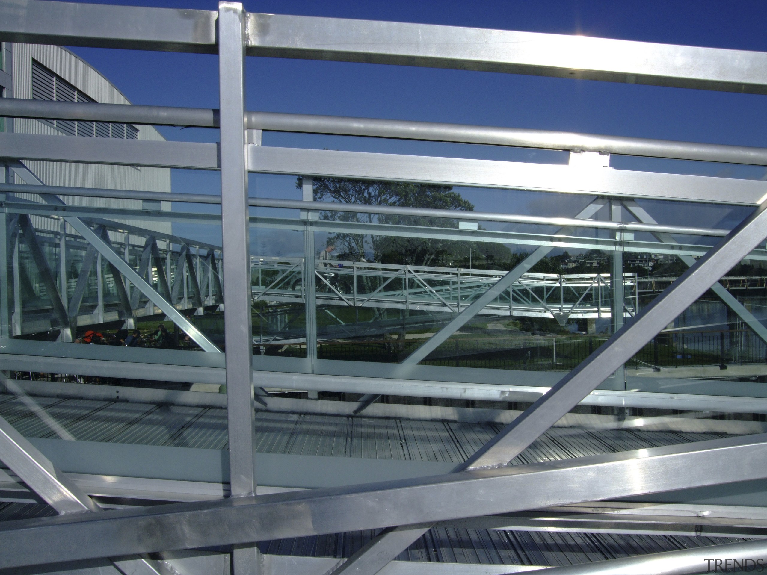 View of a pedestrian bridge in Tauranga which architecture, building, daylighting, fixed link, glass, line, metal, metropolitan area, steel, structure, gray