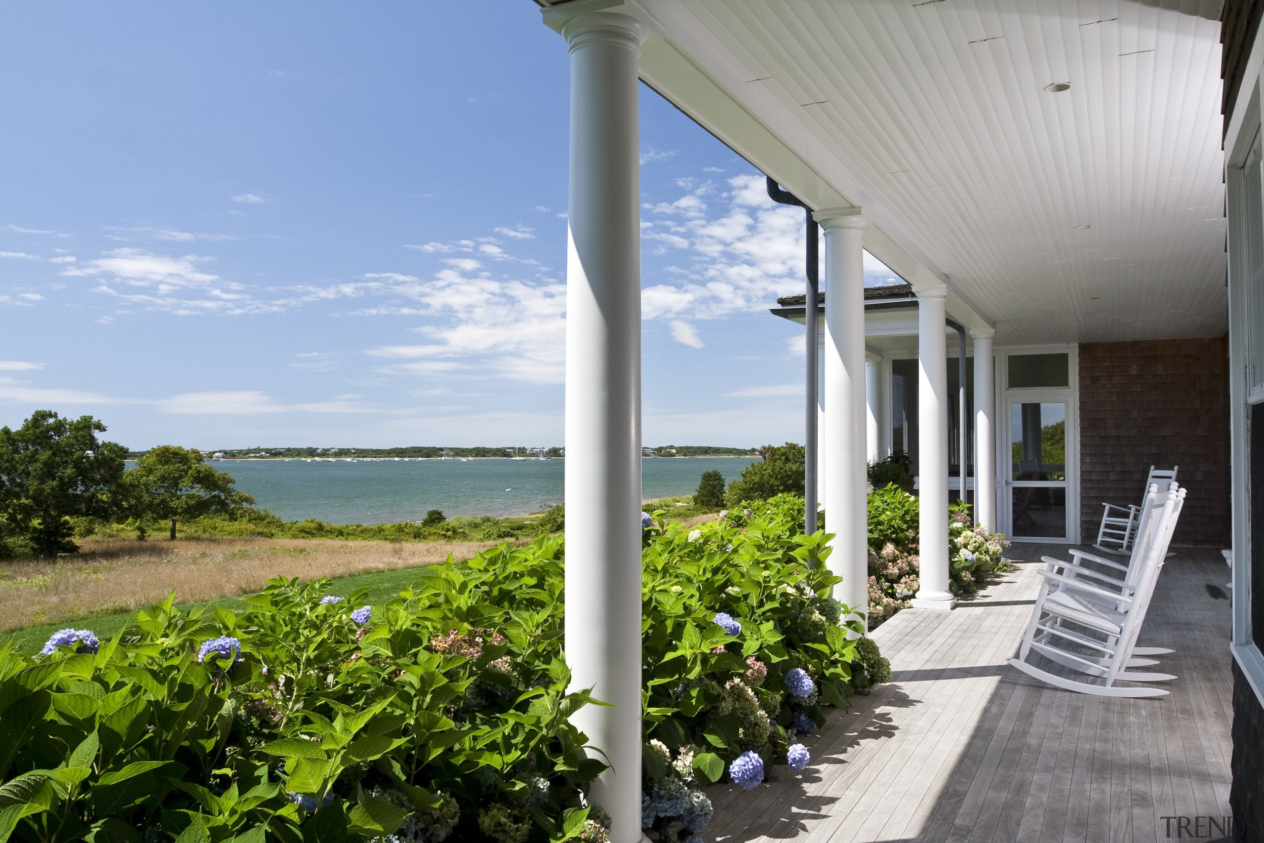 Exterior view of a New-England styled vacation home. cottage, estate, home, house, outdoor structure, property, real estate, sky, villa, gray