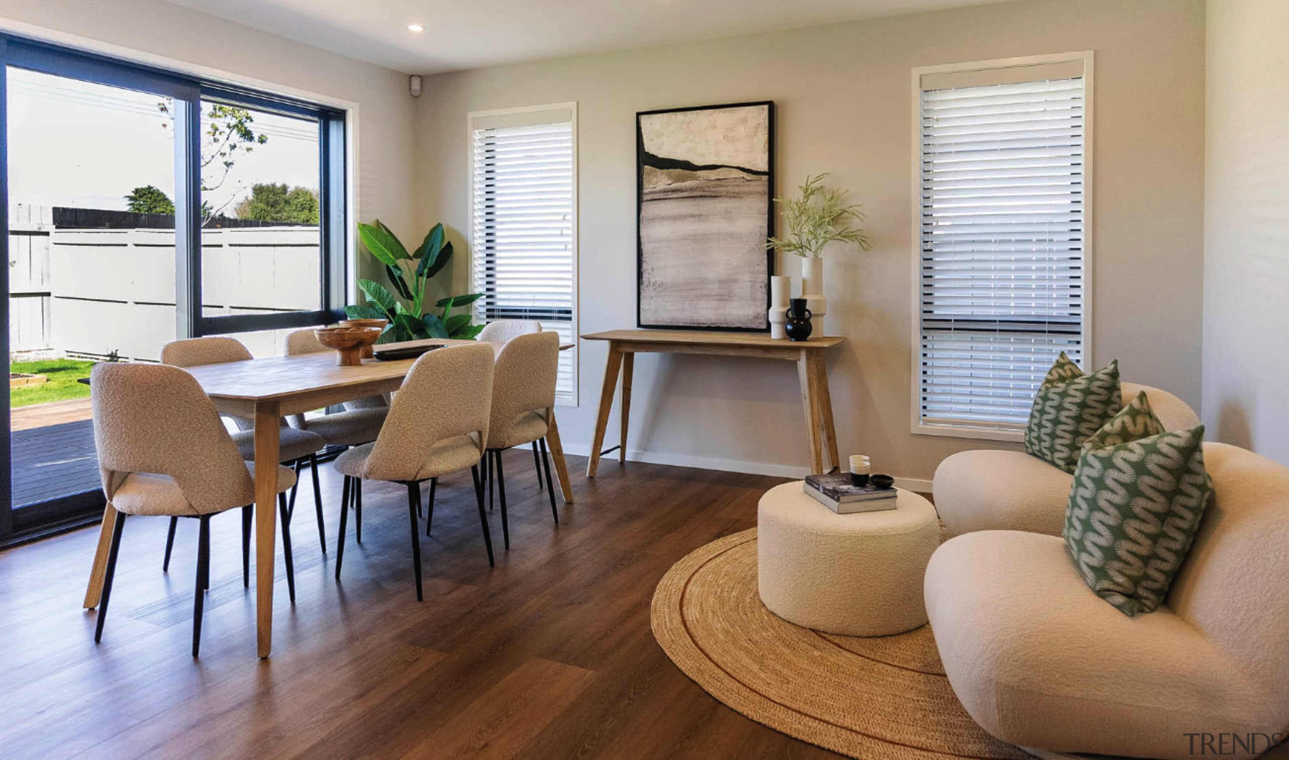 Pale tones, wood furniture and circular rattan floor 
