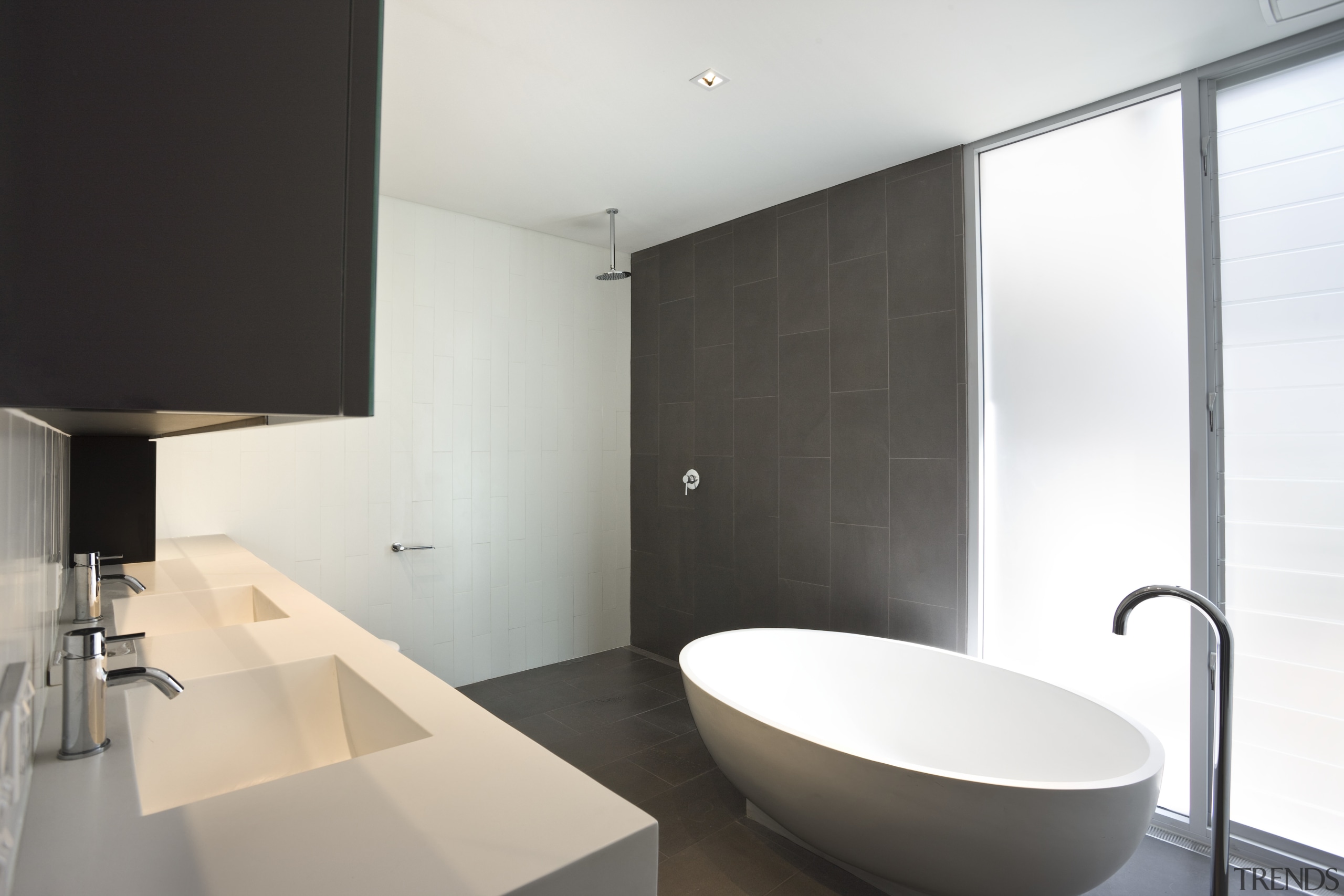 Modern bathroom features bathtub and wall tiles - architecture, bathroom, floor, house, interior design, plumbing fixture, product design, property, room, sink, tap, white, black