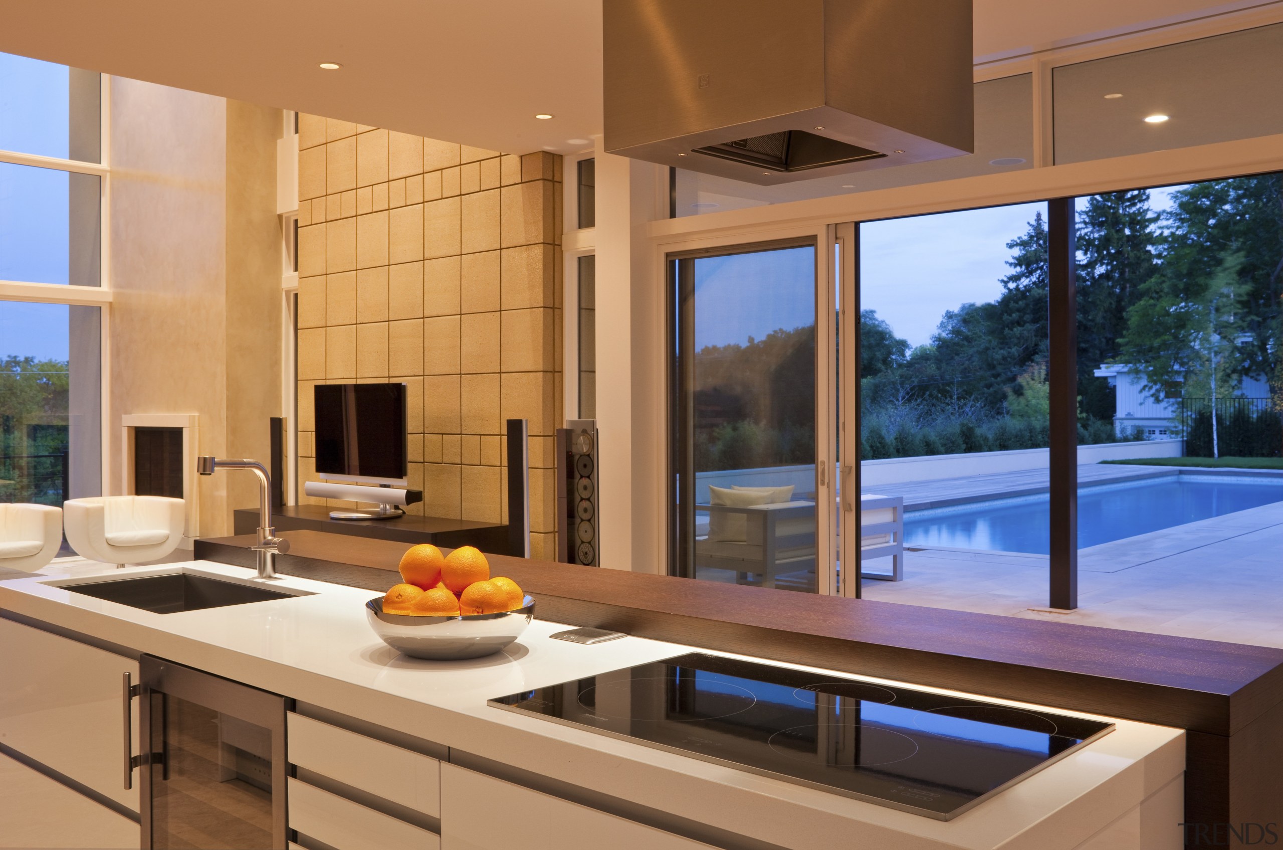 Kitchen island with pool in the distance outside architecture, countertop, daylighting, estate, house, interior design, kitchen, real estate, window, orange, brown