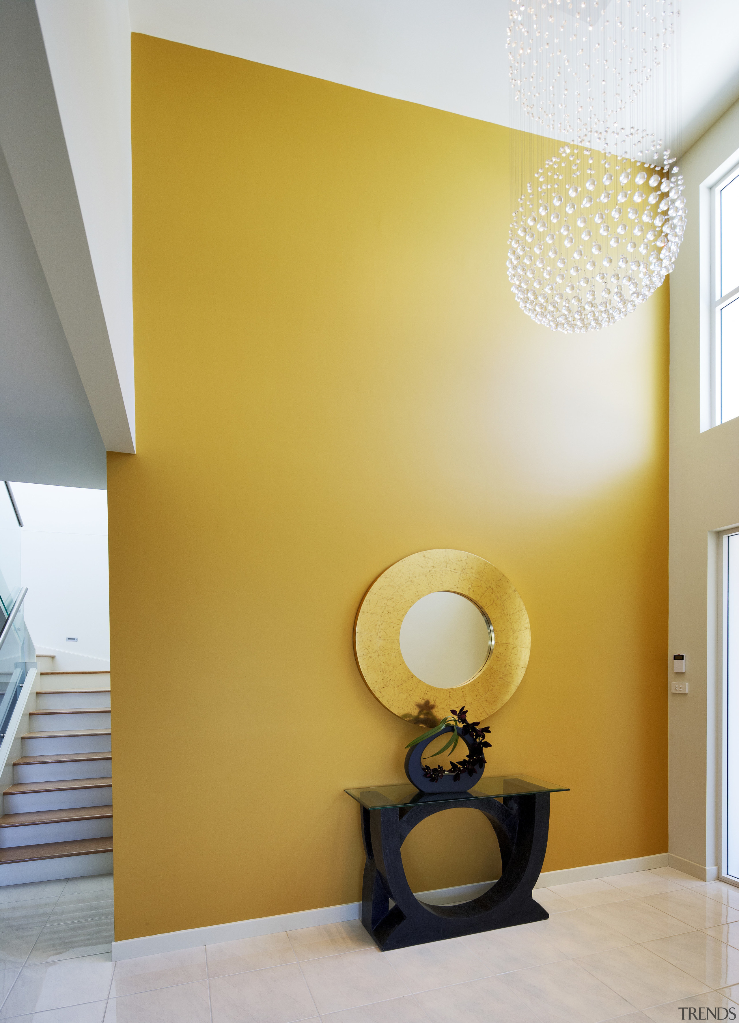 View of the entranceway to this contemporary home architecture, ceiling, daylighting, home, house, interior design, light fixture, lighting, paint, product design, room, table, wall, yellow, orange