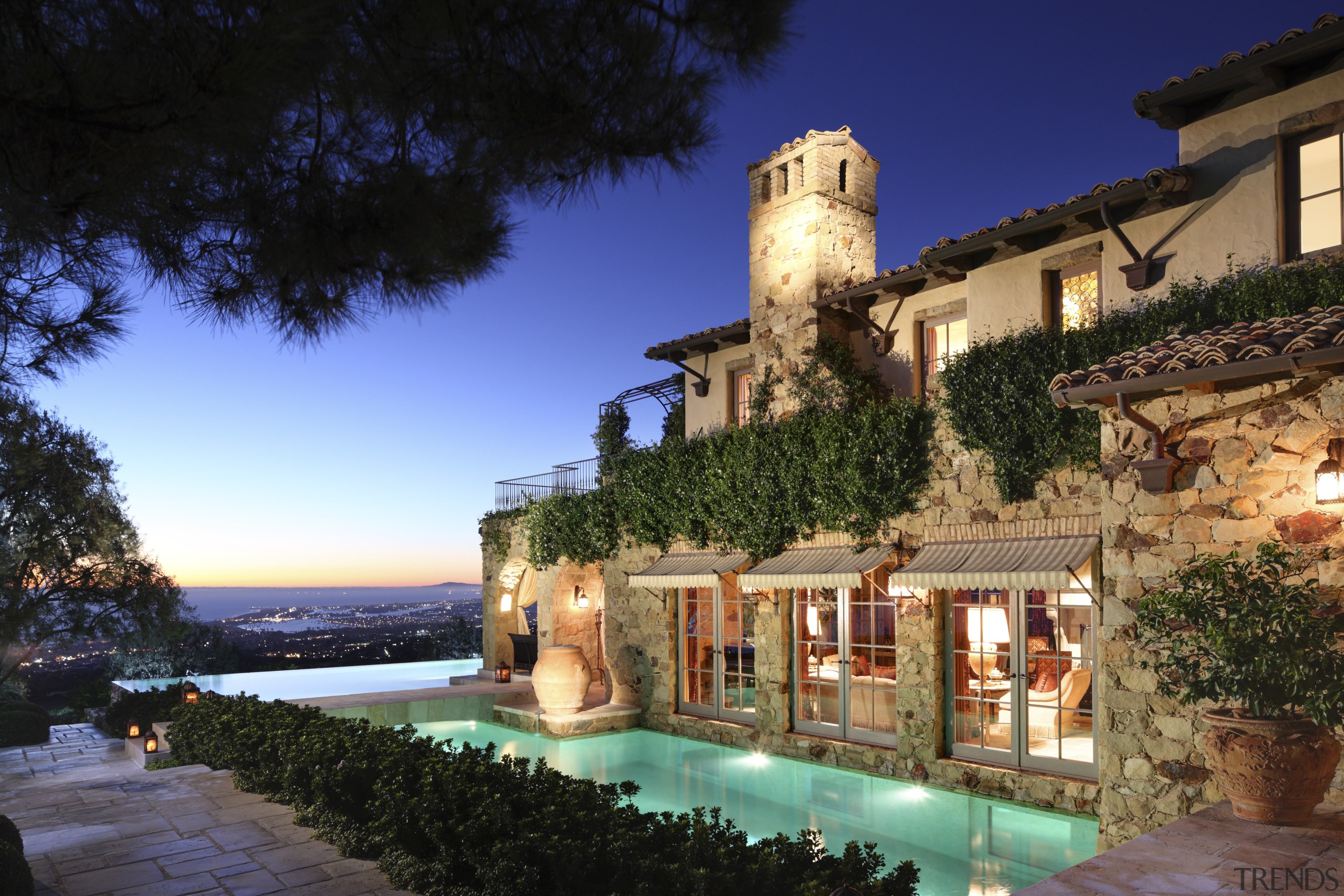 Exterior view of house with pool in foreground. building, estate, hacienda, home, hotel, lighting, mansion, property, real estate, resort, sky, tourism, villa, black, blue