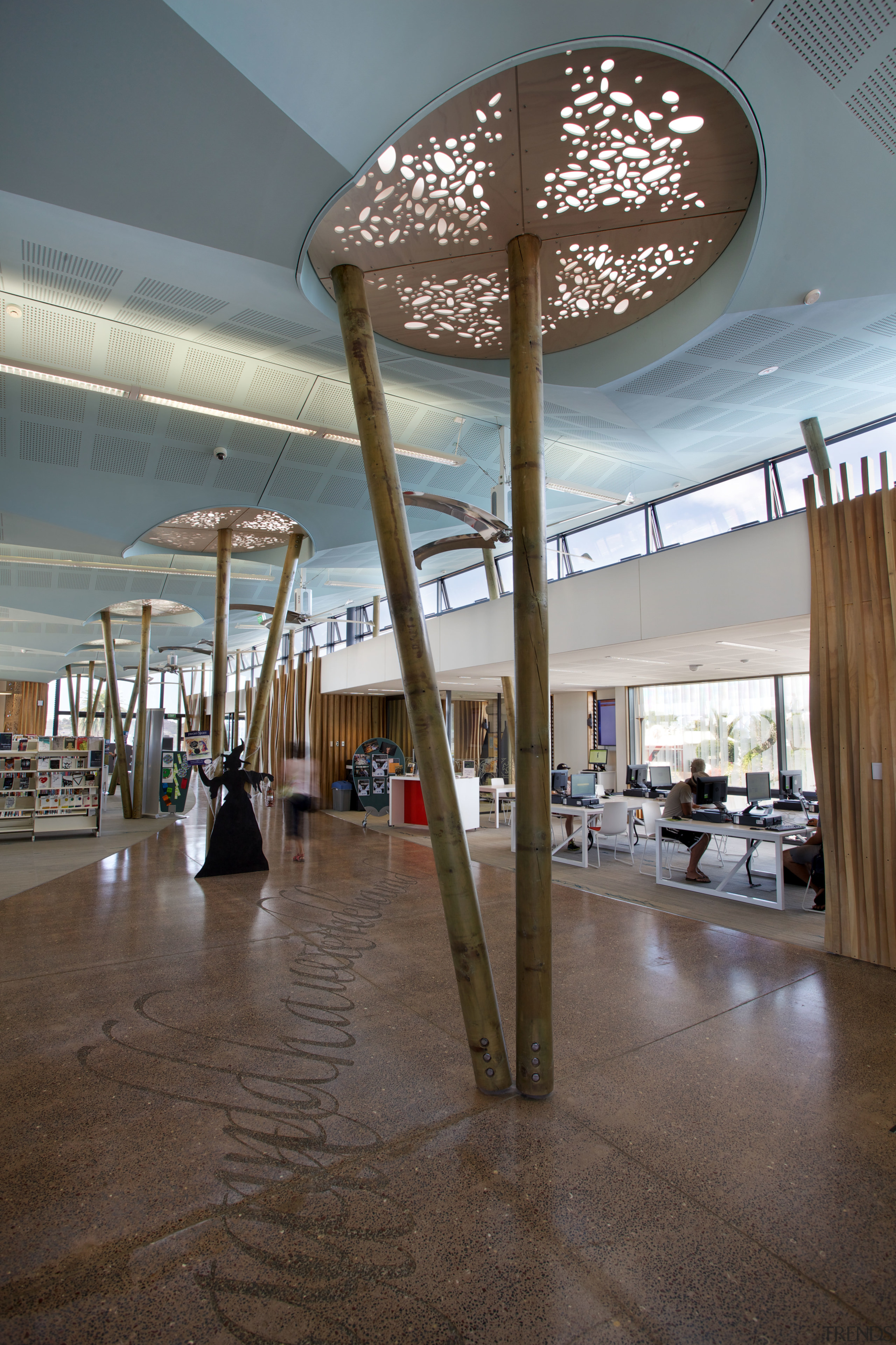 In the new Waiheke library, tall timber columns architecture, ceiling, daylighting, floor, flooring, interior design, lobby, structure, gray