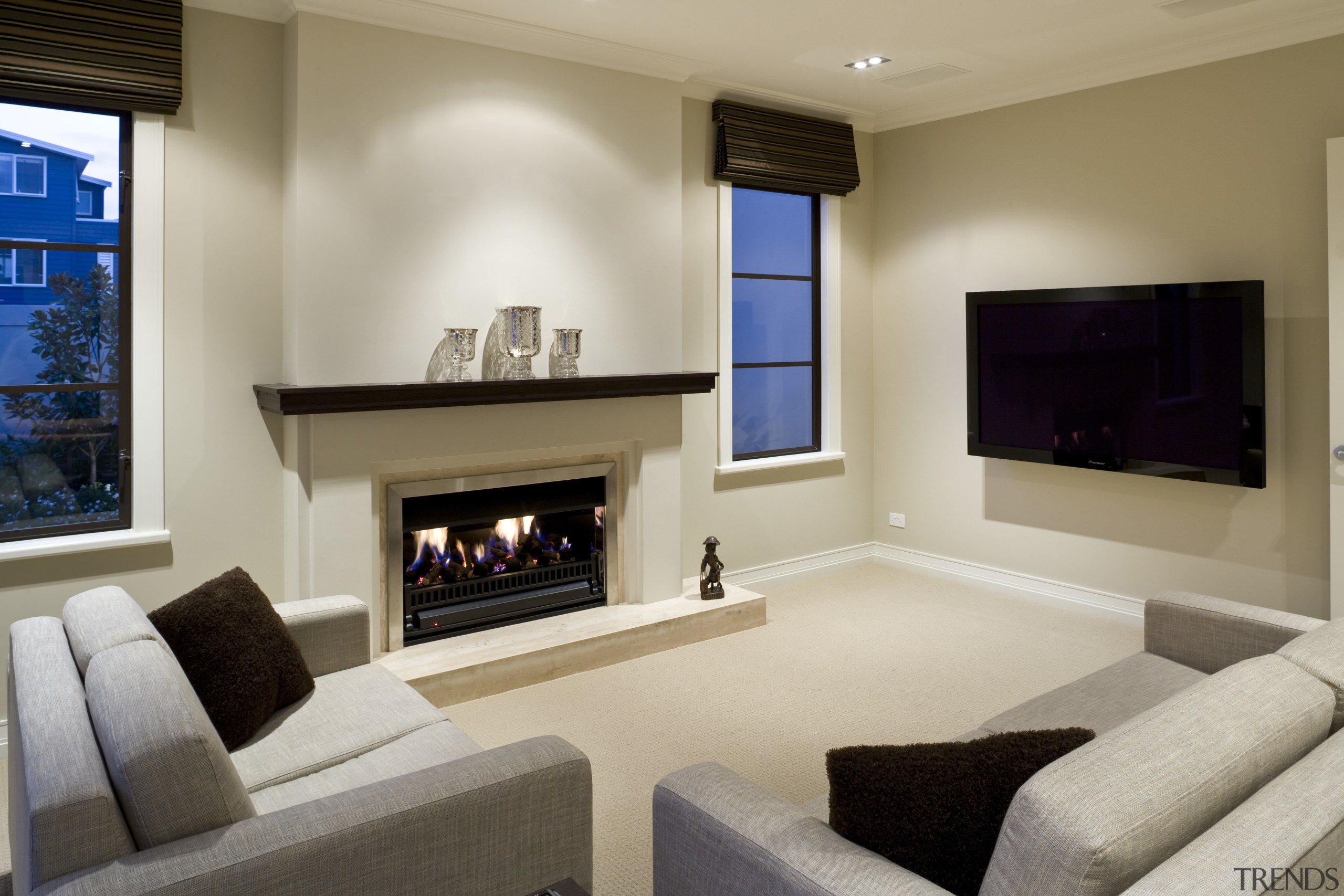 View of a living area inside this Mediterranean-style estate, fireplace, floor, flooring, hearth, home, interior design, living room, property, real estate, room, wall, gray