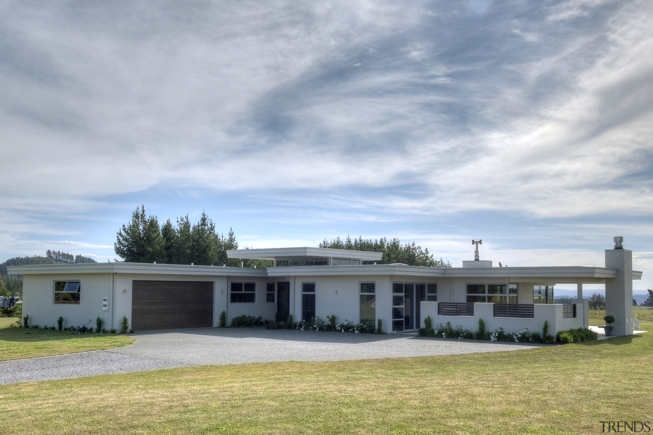 View of a house clad in Rockcote plaster. cloud, cottage, elevation, estate, farmhouse, home, house, landscape, property, real estate, roof, sky, gray