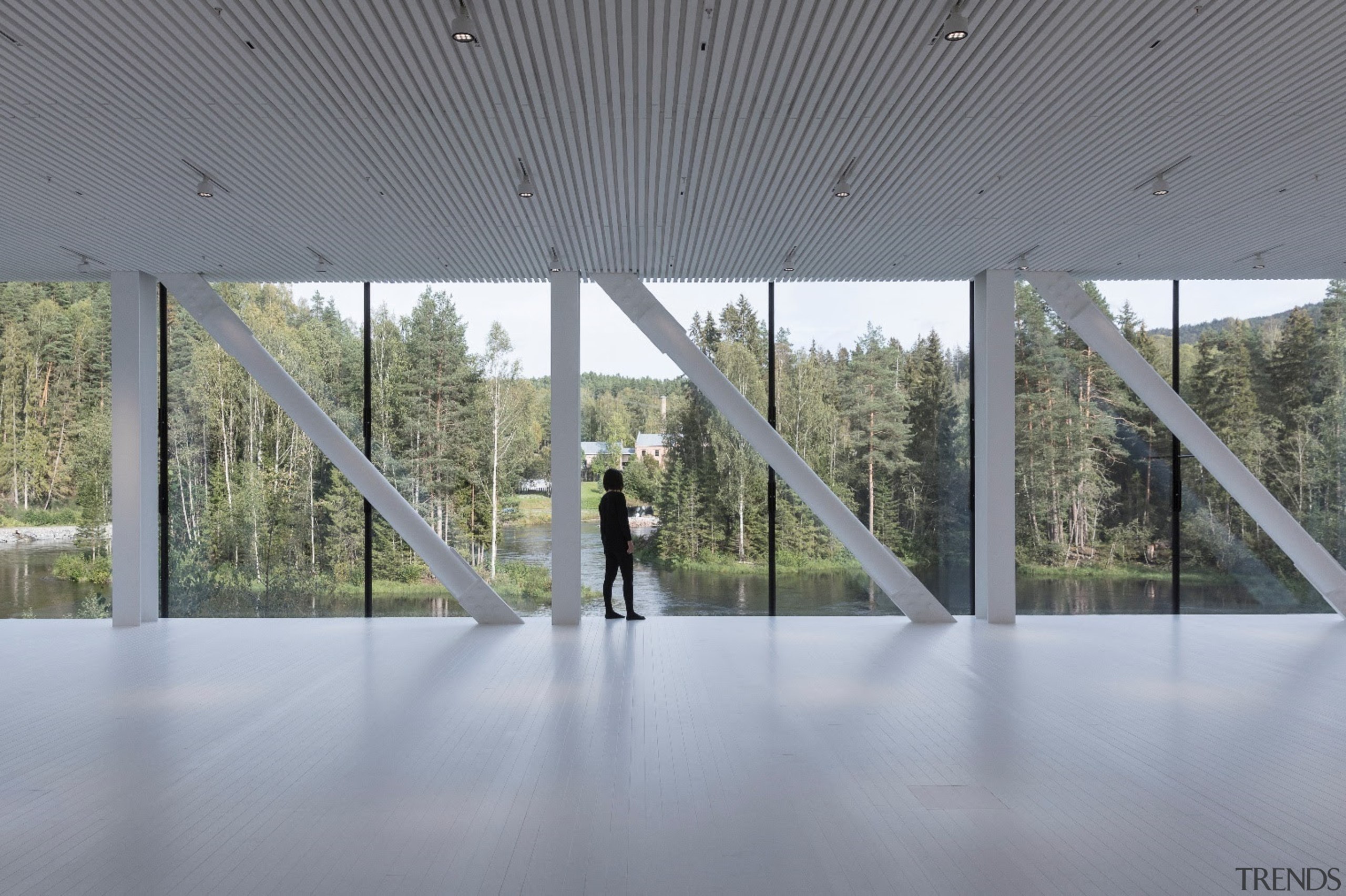 On the north end, a full-height glass wall architecture, building, ceiling, daylighting, floor, glass, house, interior design, line, pavilion, reflection, tourist attraction, tree, window, gray