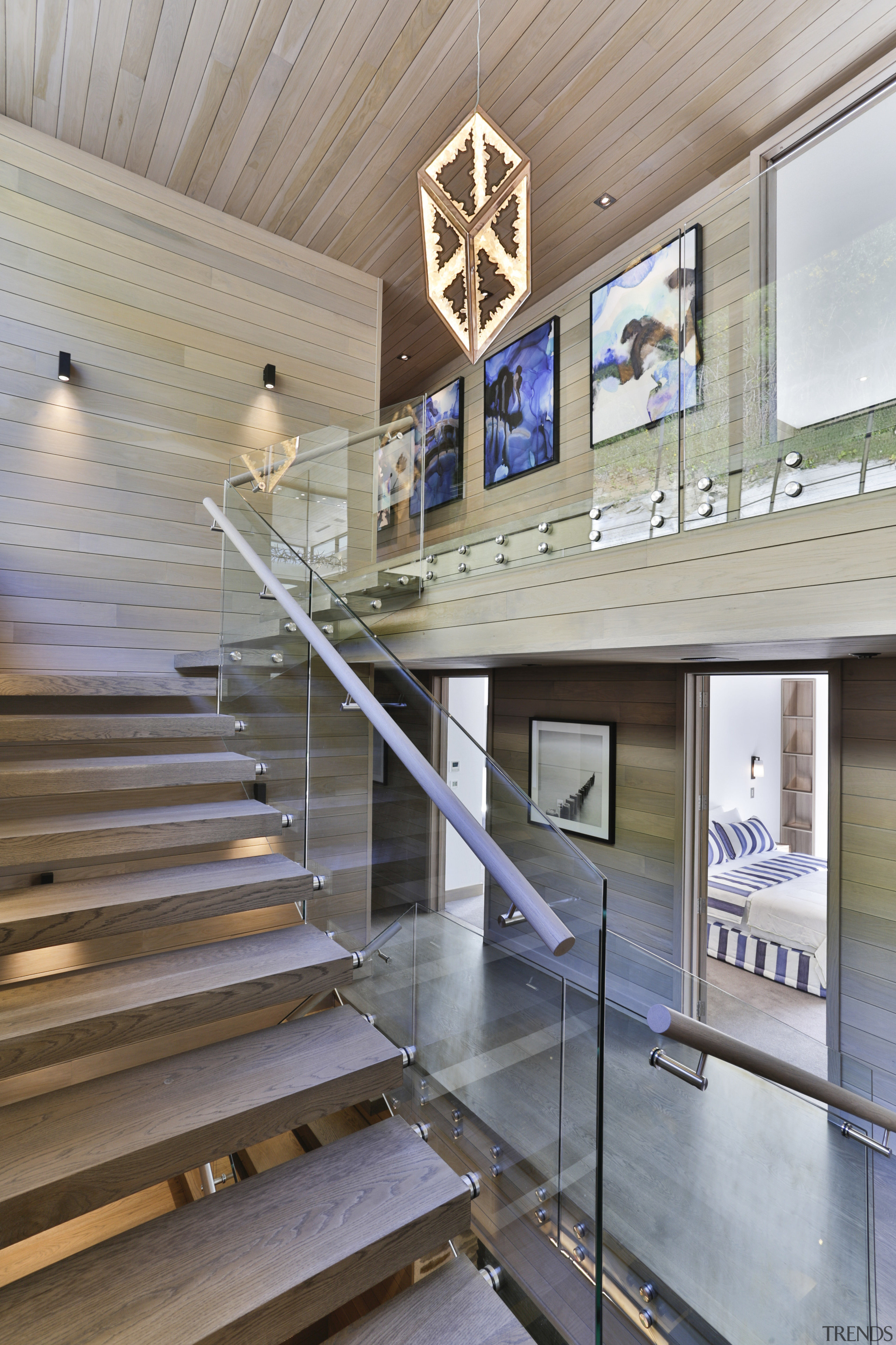 A basement level lobby with a grand staircase architecture, ceiling, daylighting, floor, handrail, interior design, lobby, stairs, tourist attraction, wood, gray