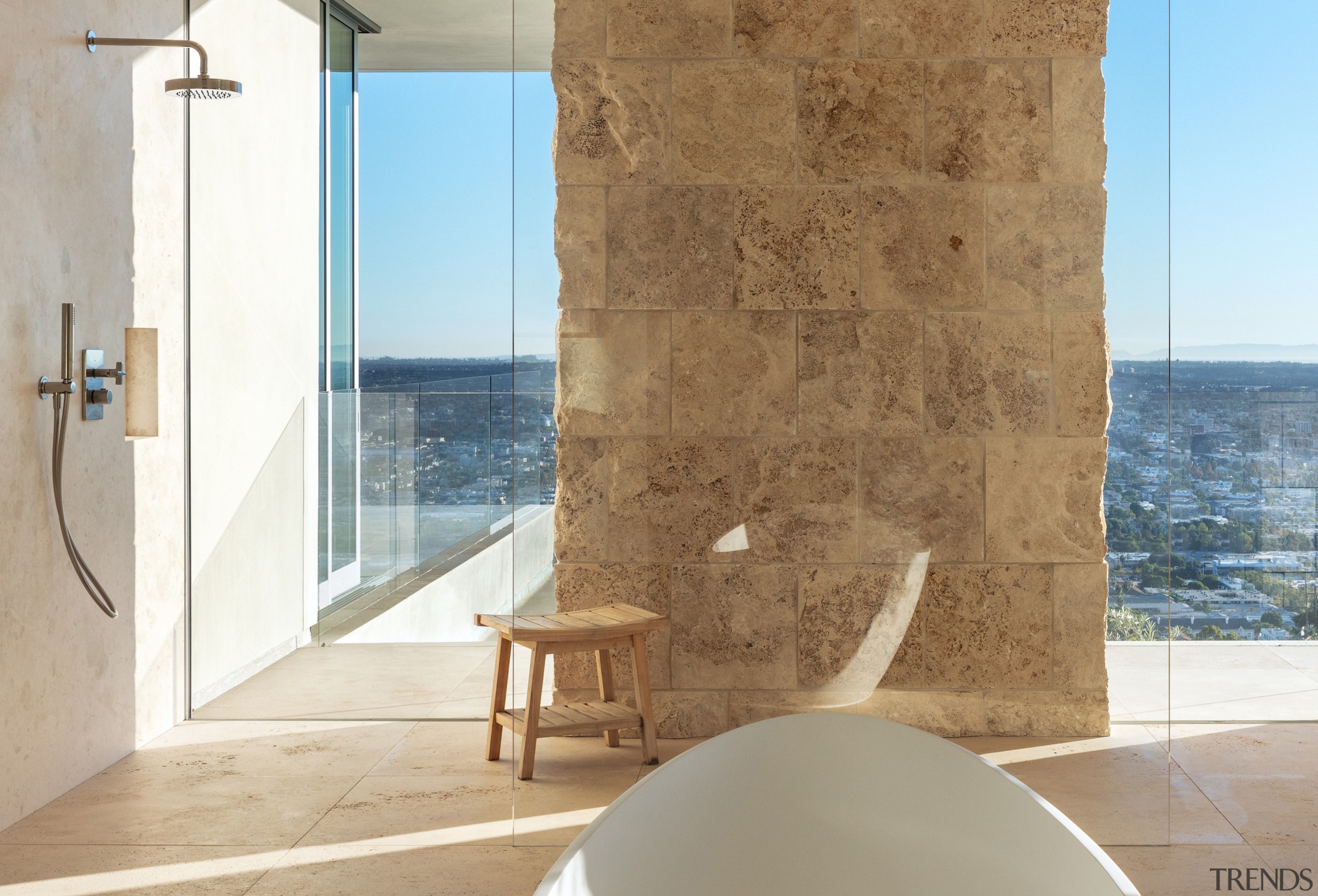 Stone blocks and glass semi-enclose the understated shower 