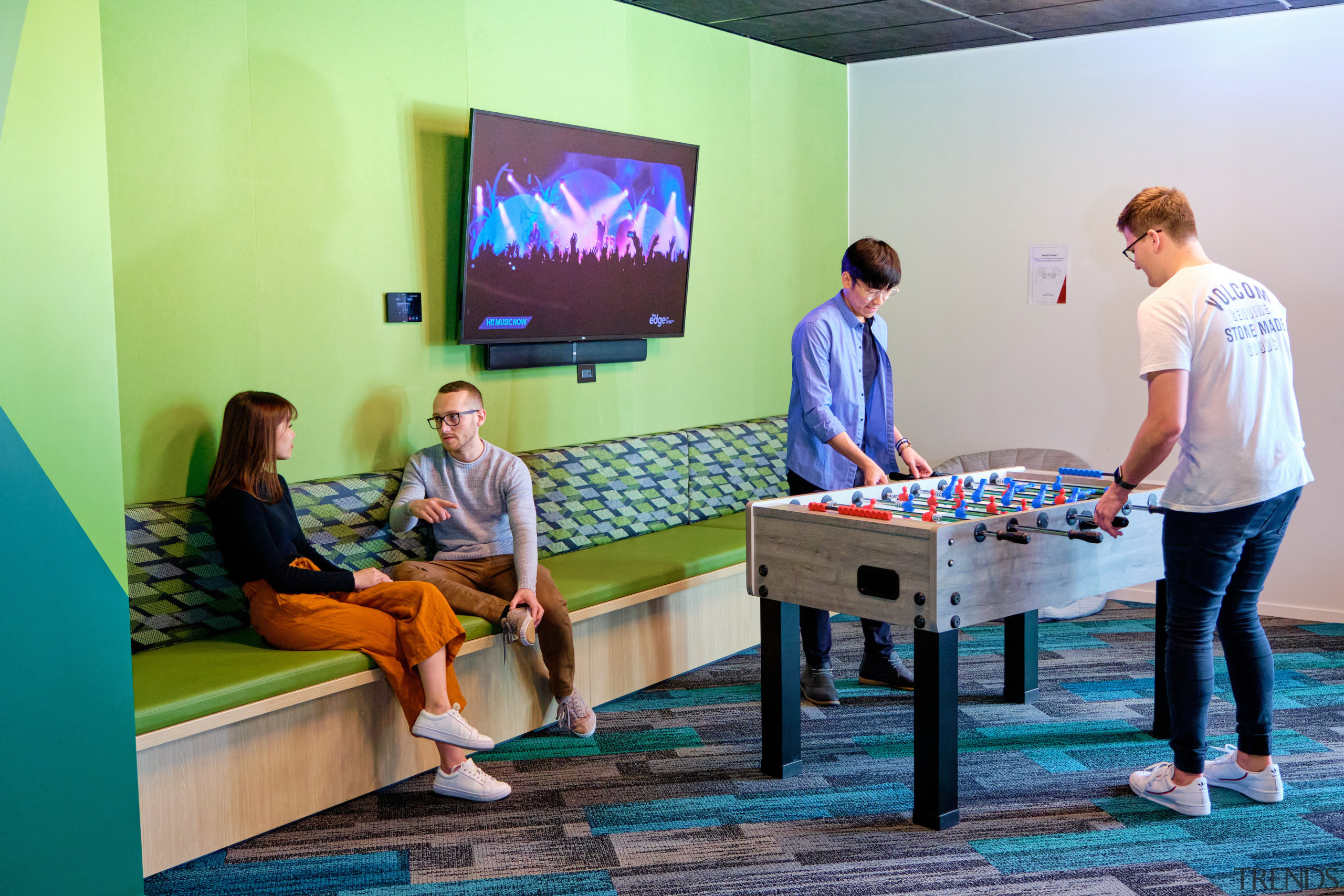 Colourful banquette seating and colourful carpet  contribute to 