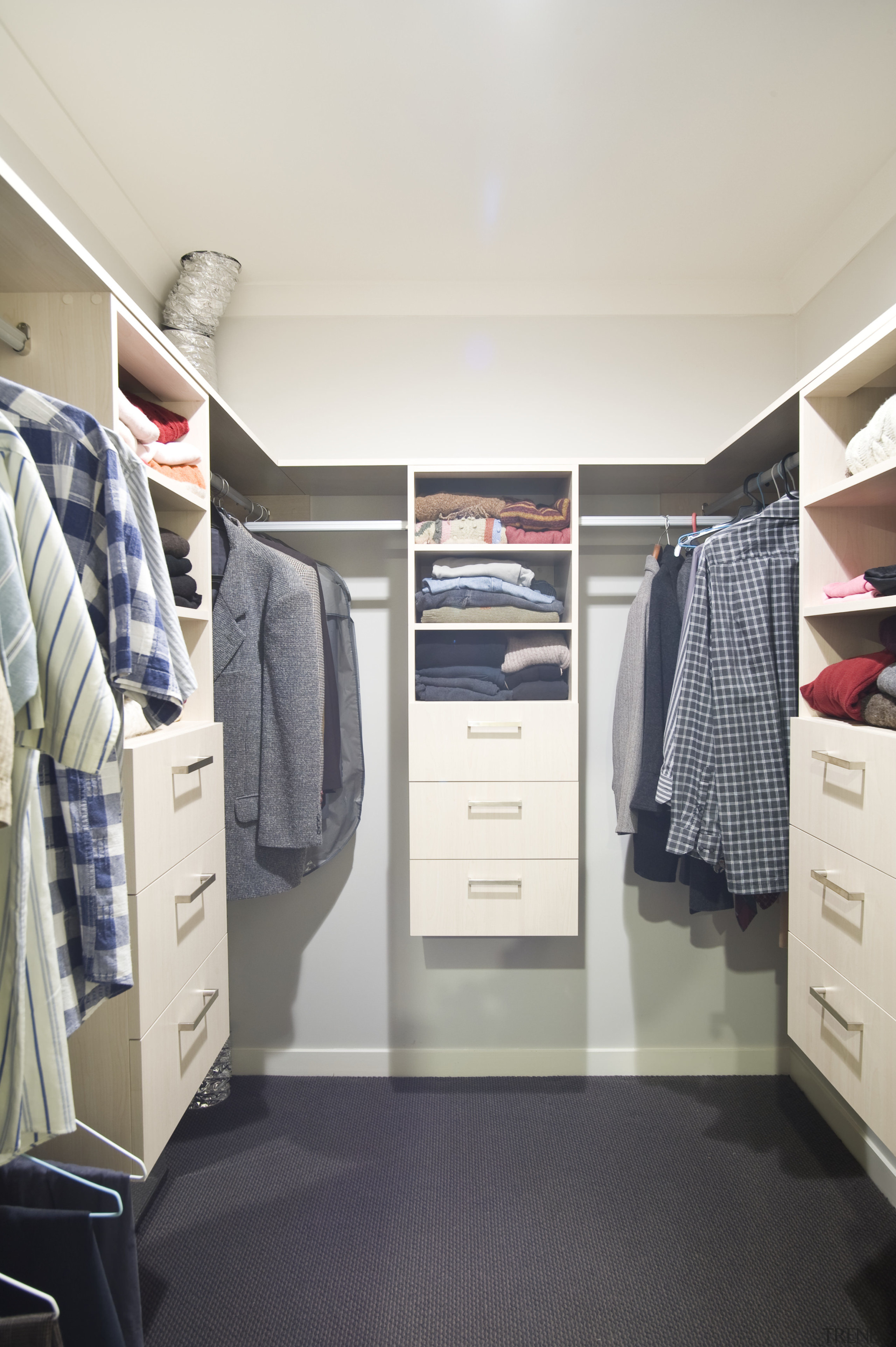 View of walk-in closet cabinetry, shelving and carpeted closet, floor, furniture, product, room, wardrobe, white, gray