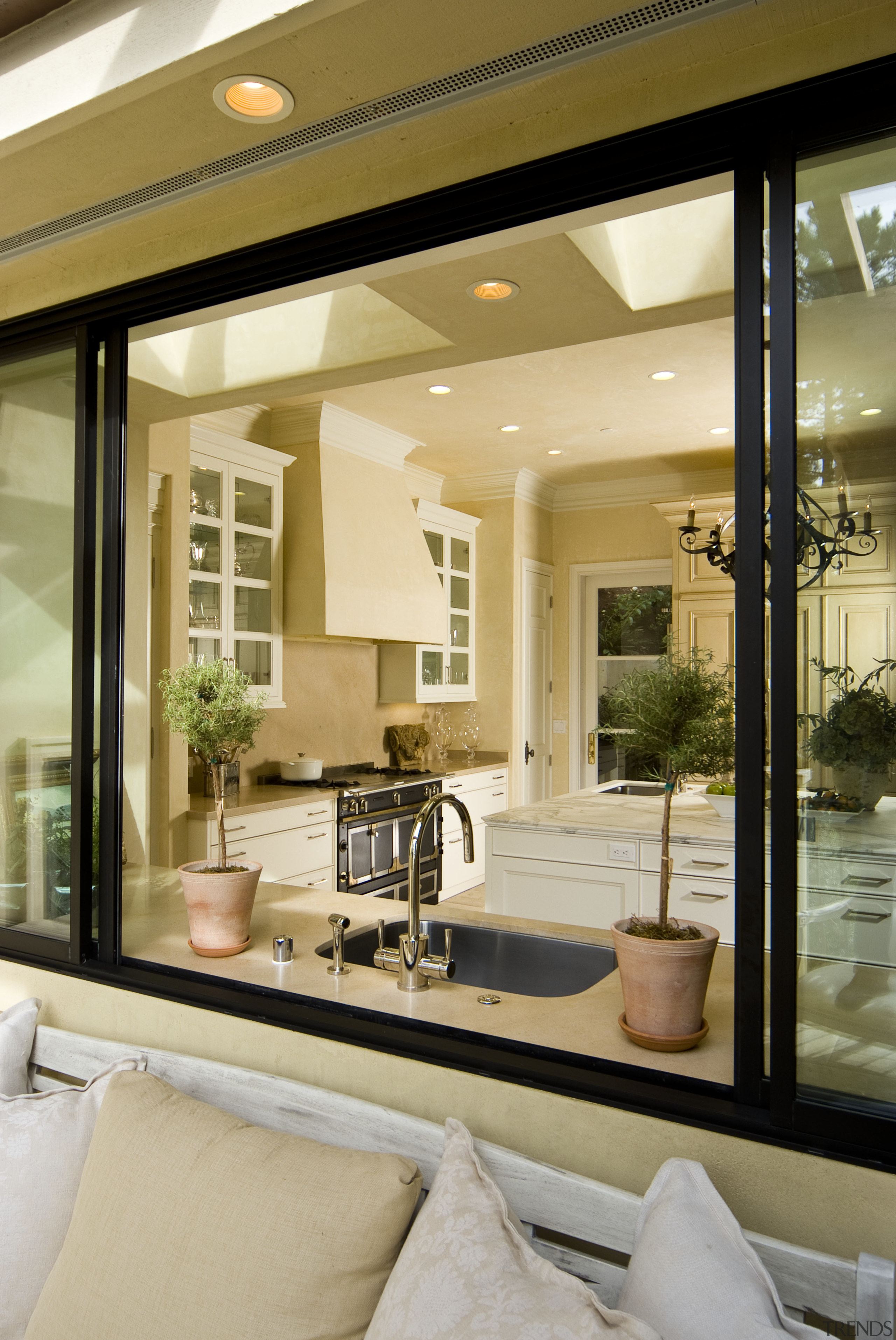 View through window to neutral toned kitchen. - ceiling, home, interior design, living room, window, orange, brown