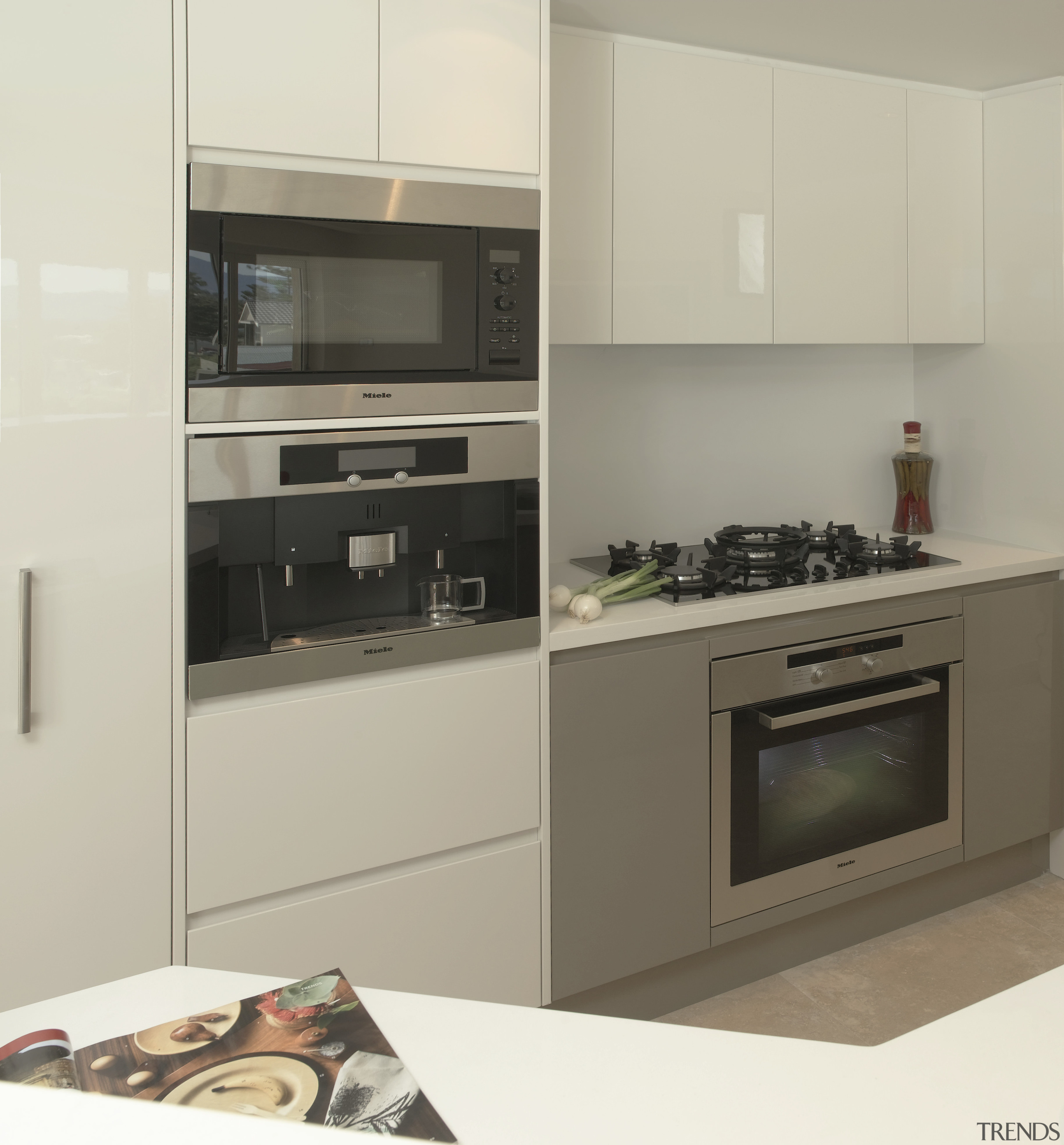 Matching appliances enhance the sophisticated look of the cabinetry, countertop, cuisine classique, home appliance, interior design, kitchen, kitchen appliance, kitchen stove, microwave oven, oven, gray