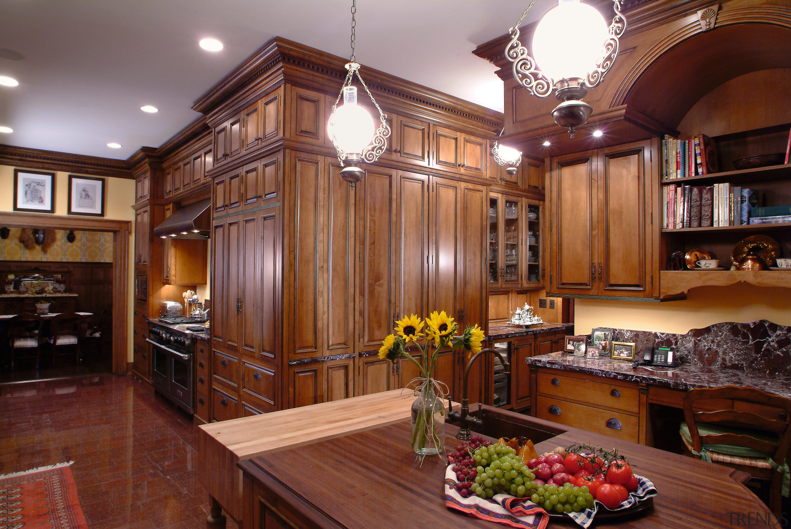 A view of this kitchen features cabinets by cabinetry, ceiling, countertop, cuisine classique, hardwood, interior design, kitchen, living room, real estate, room, wood, red, brown