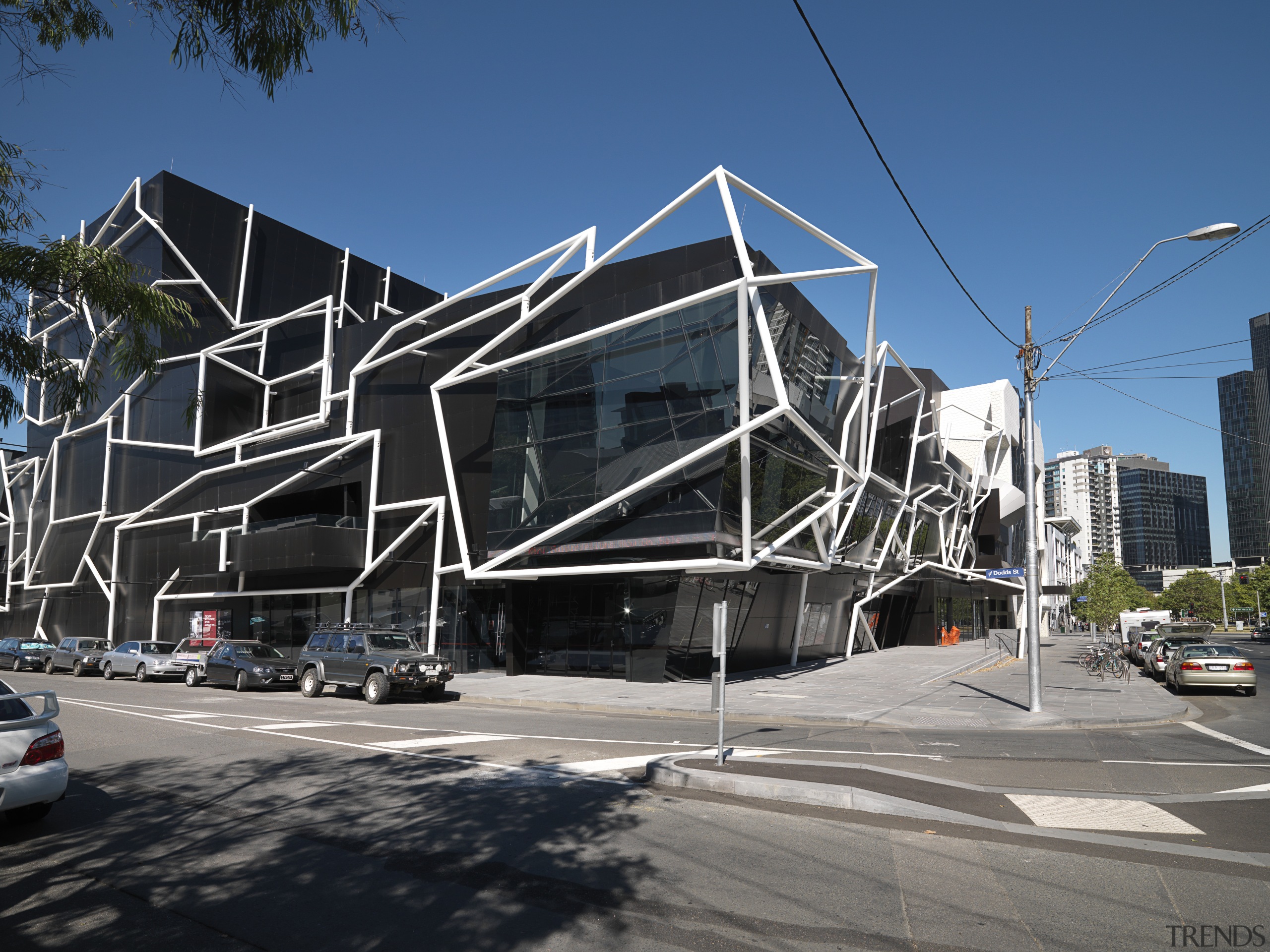 Exterior view of the MTC which features white architecture, building, commercial building, condominium, corporate headquarters, facade, headquarters, house, metropolis, metropolitan area, mixed use, neighbourhood, real estate, residential area, sky, structure, black