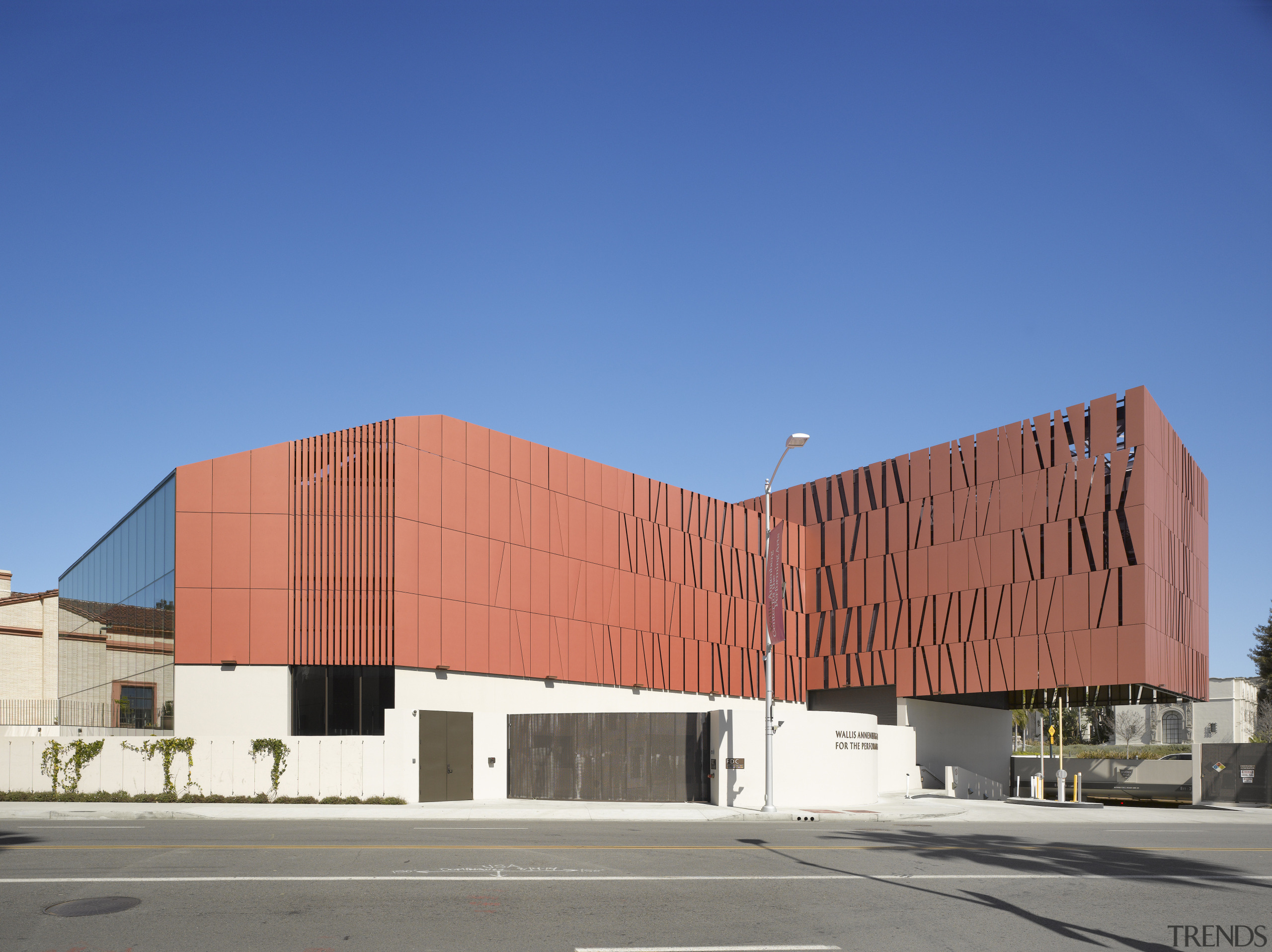 The dynamic cladding on the theatre weaves in architecture, building, commercial building, corporate headquarters, daytime, elevation, facade, headquarters, landmark, residential area, sky, structure, blue