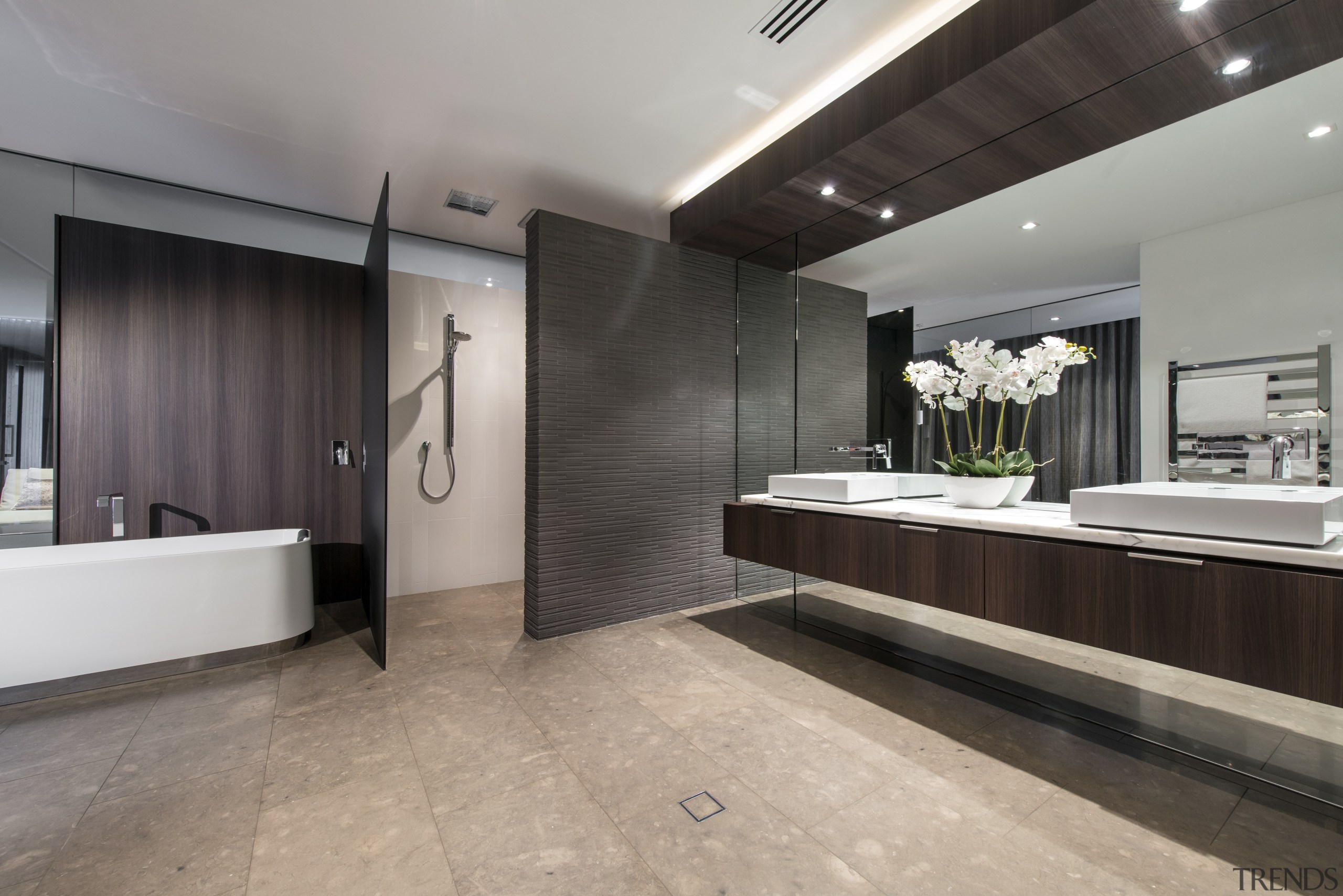 A wall-height mirror behind the vanity makes this bathroom, floor, flooring, interior design, room, tile, wood flooring, gray, black