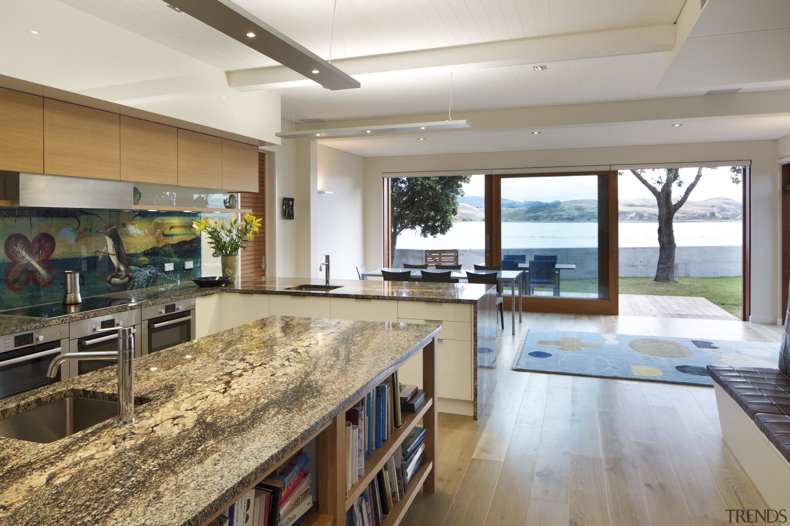 The interiors of this modern seaside house feature countertop, estate, house, interior design, kitchen, real estate, gray