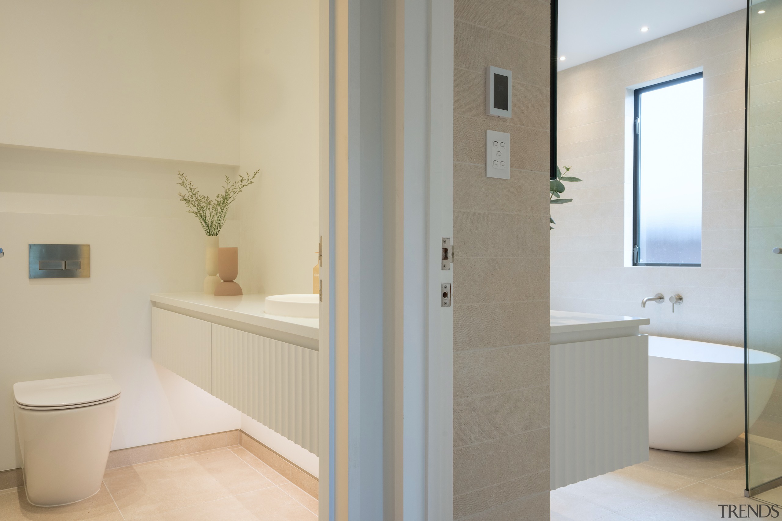 Side-by-side bathrooms showing the crenulated vanity finish featured 