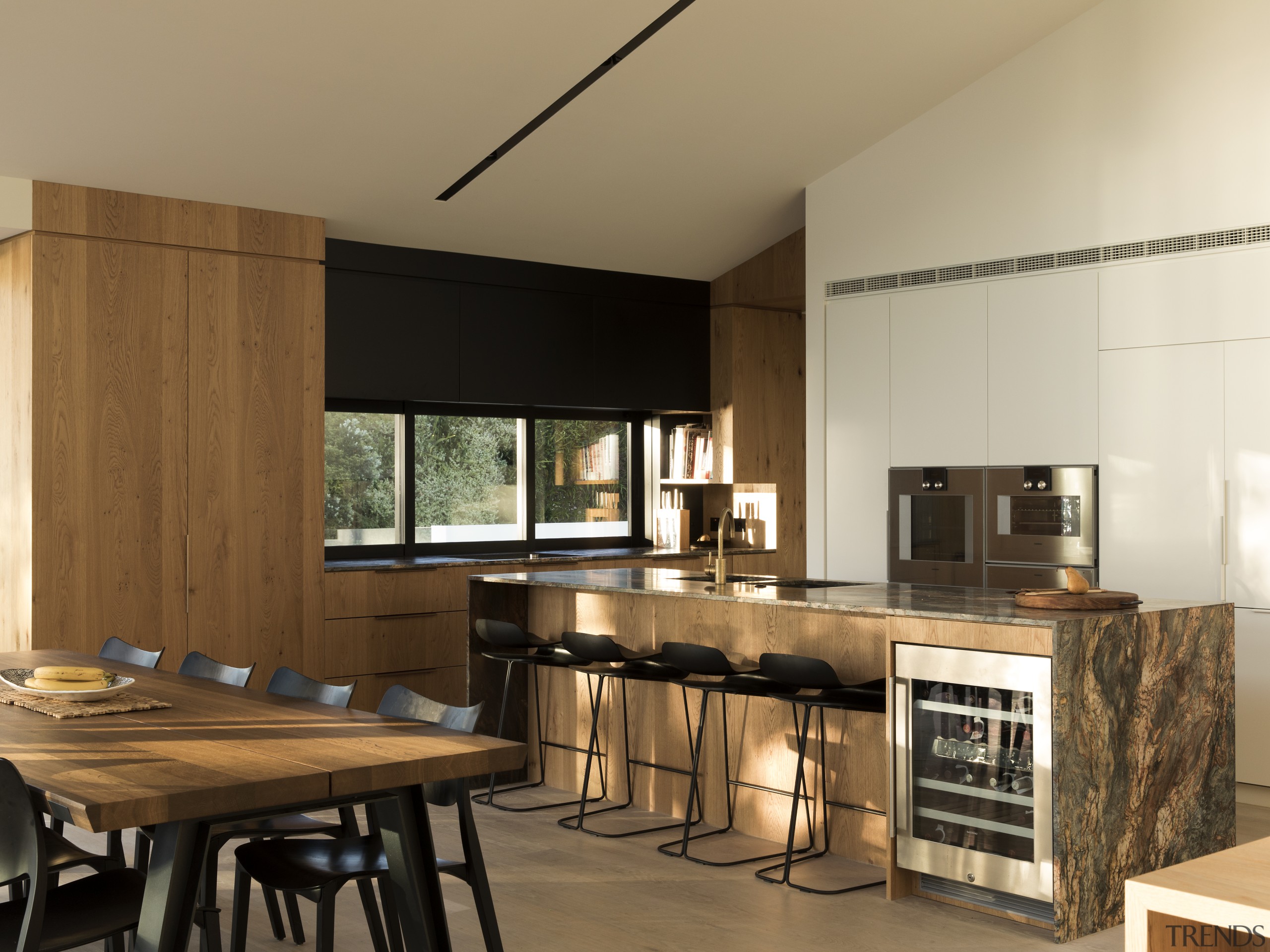 This slender marble benchtop overhangs the front of countertop, cuisine classique, interior design, kitchen, brown