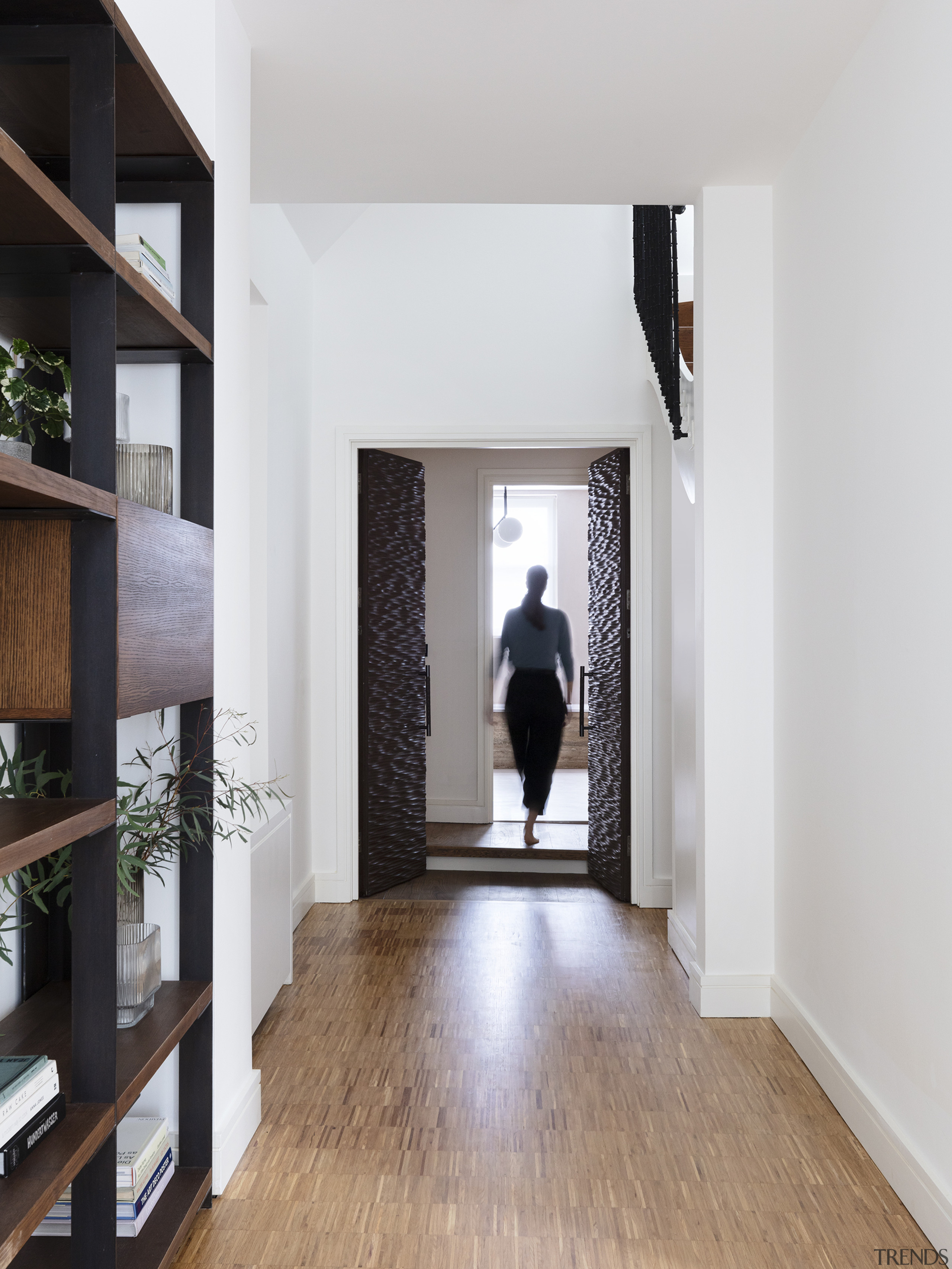 Hallway to master bedroom with wooden storage and 