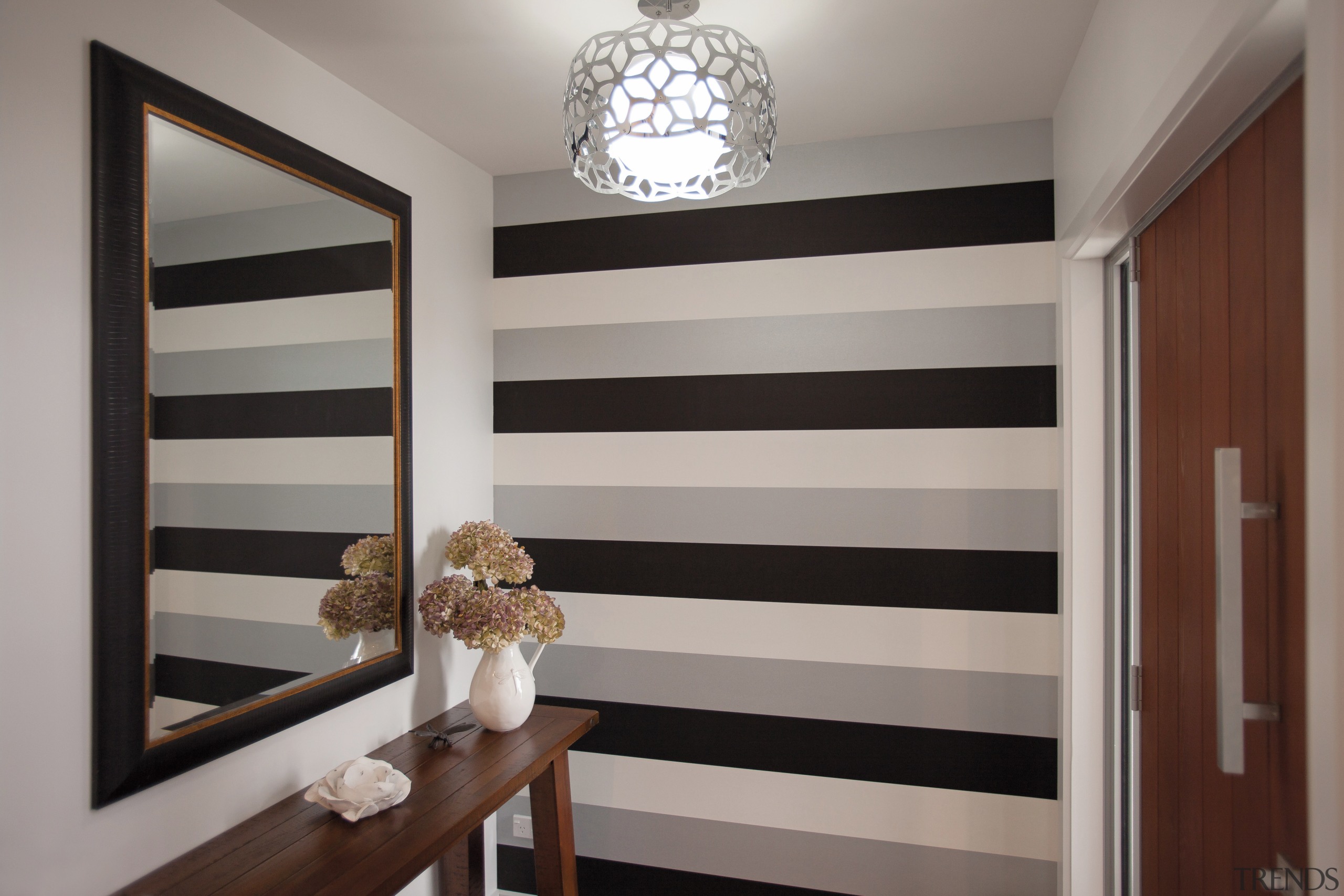 A dramatic striped wallpaper defines the entry to ceiling, door, home, interior design, room, wall, window, window covering, gray