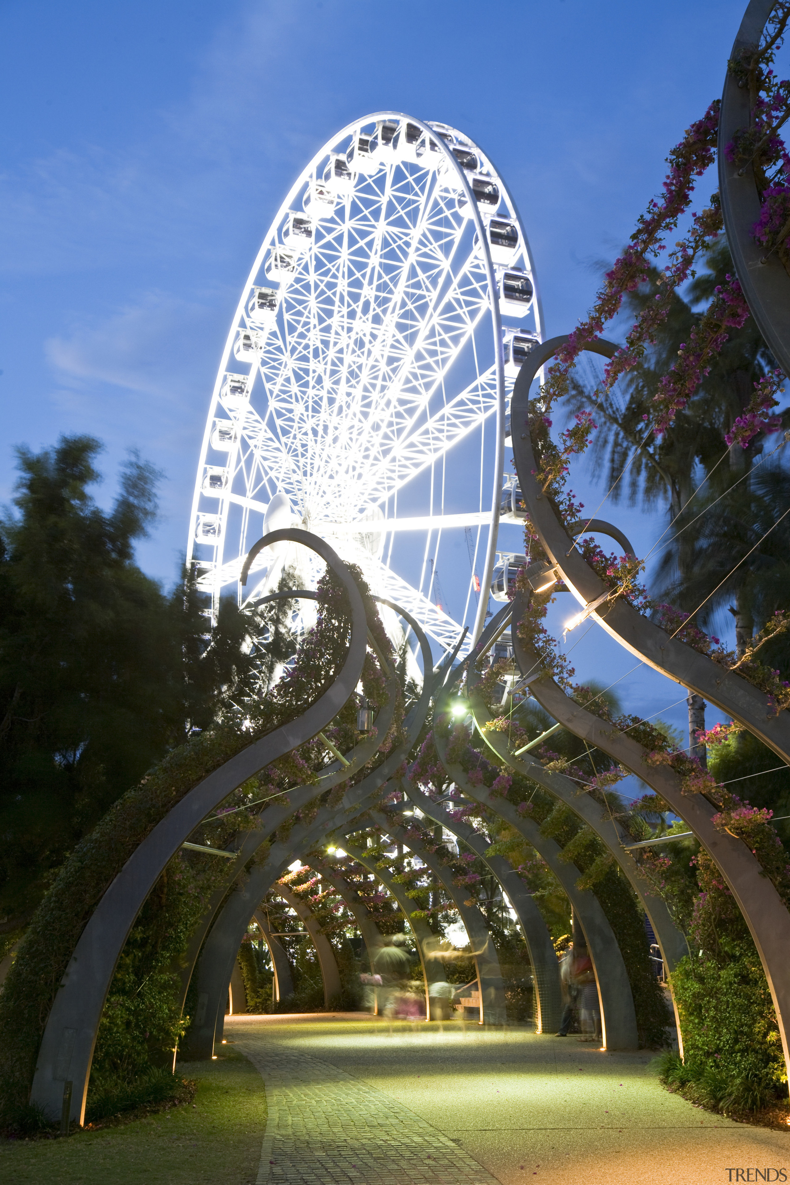 Image of a development which is part of architecture, daytime, ferris wheel, landmark, leaf, metropolis, metropolitan area, park, recreation, reflection, sky, tourist attraction, tree, brown