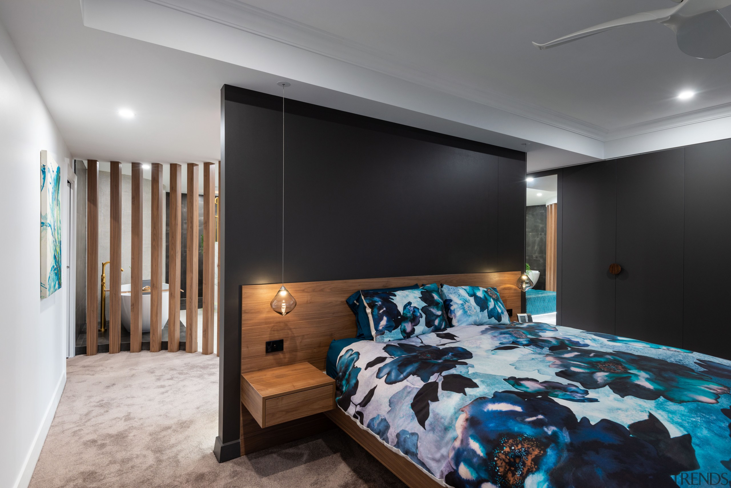 ​​​​​​​Dark wall and cabinet tones accentuate the warmth architecture, bed, bed frame, bed sheet, bedding, bedroom, building, ceiling, floor, furniture, hardwood, home, house, interior design, linens, loft, mattress, property, real estate, room, suite, wall, wood flooring, gray, black