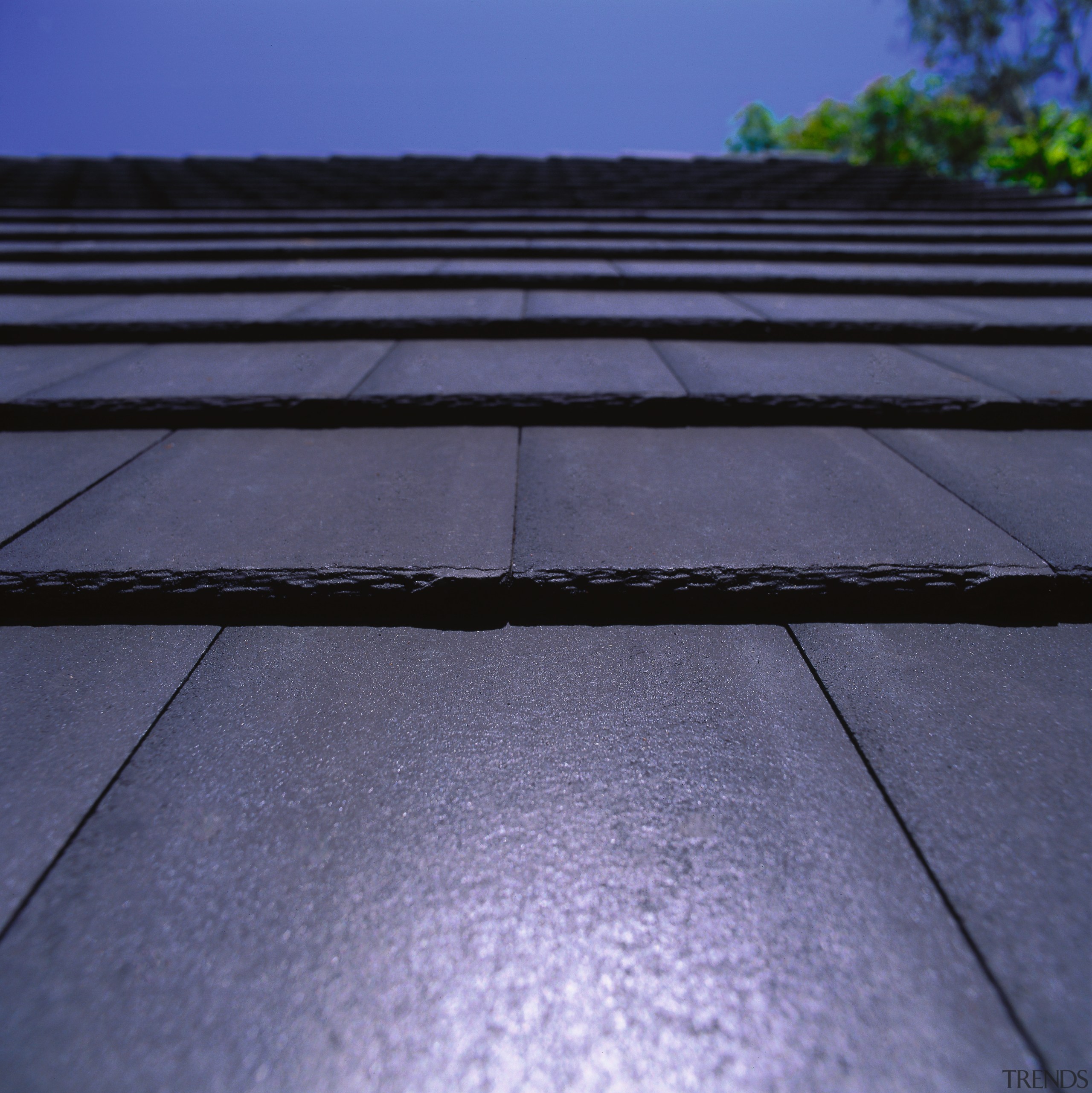 Closeup of Monier shingle roof tiles in dark asphalt, daylighting, horizon, light, line, road surface, roof, sky, sunlight, blue