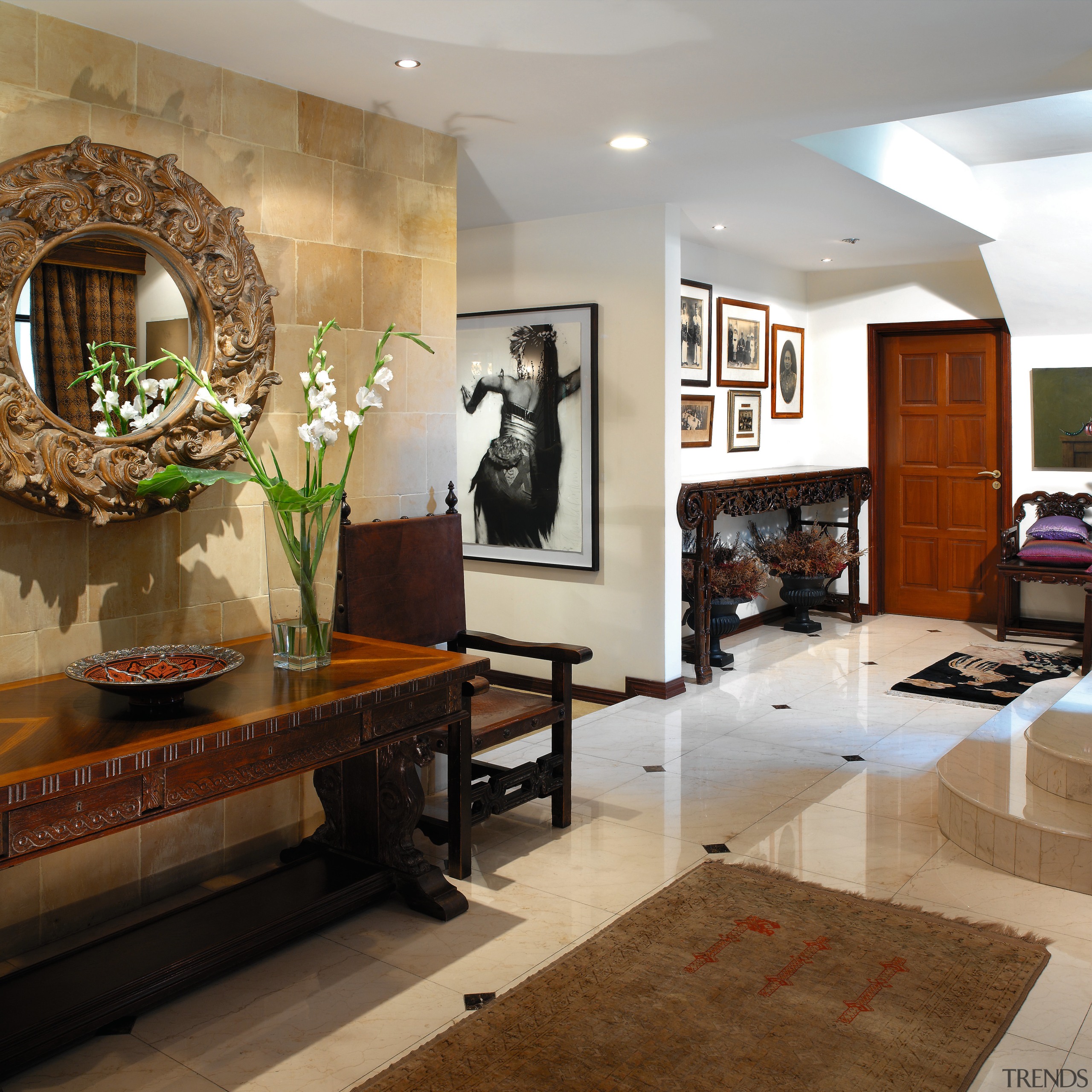 view of the entrance to this house featuring ceiling, floor, flooring, furniture, interior design, living room, lobby, room, brown, gray