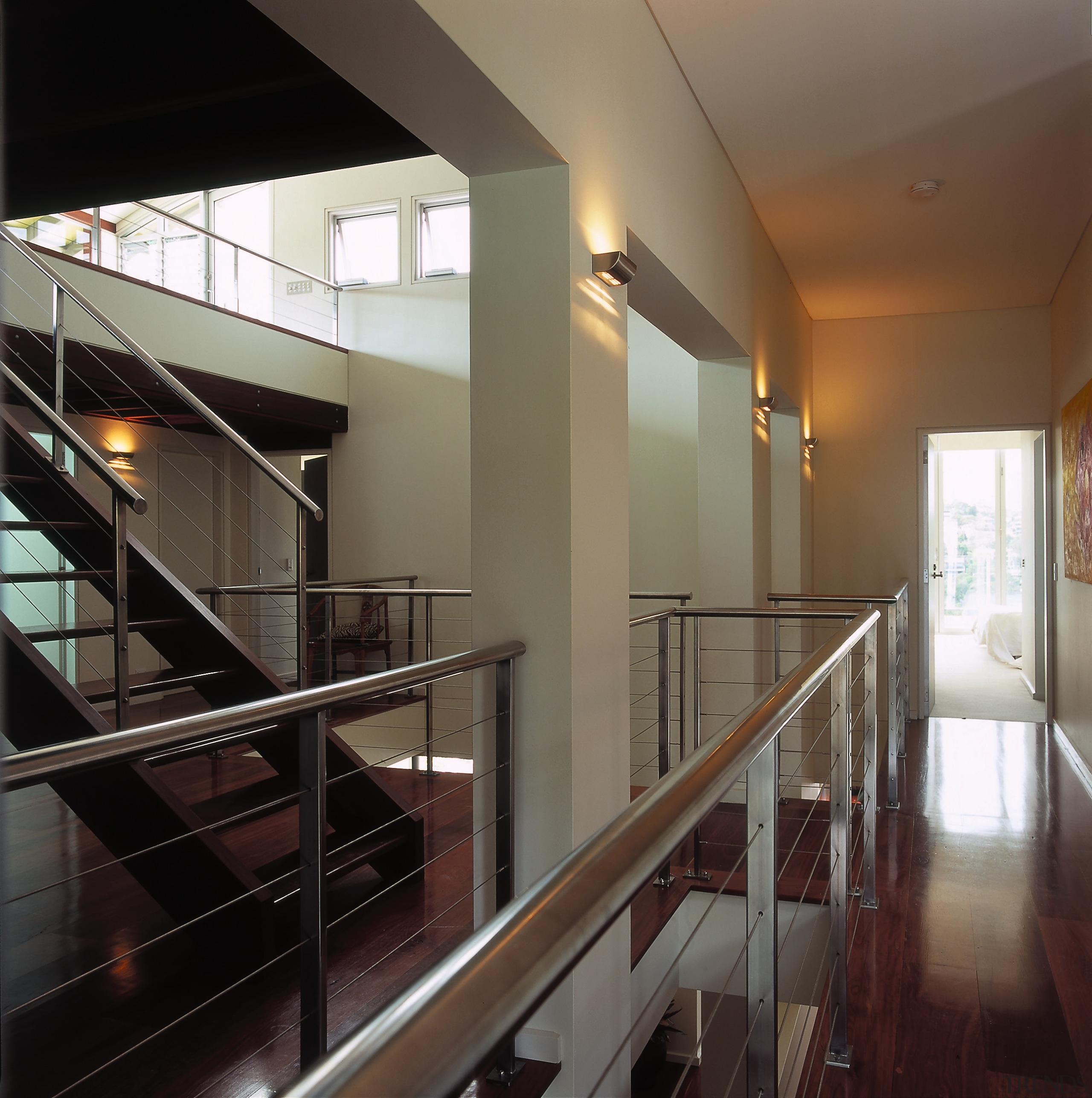 A view of the stairwell constructed from a architecture, ceiling, daylighting, floor, glass, handrail, house, interior design, lobby, property, real estate, stairs, black, brown, gray