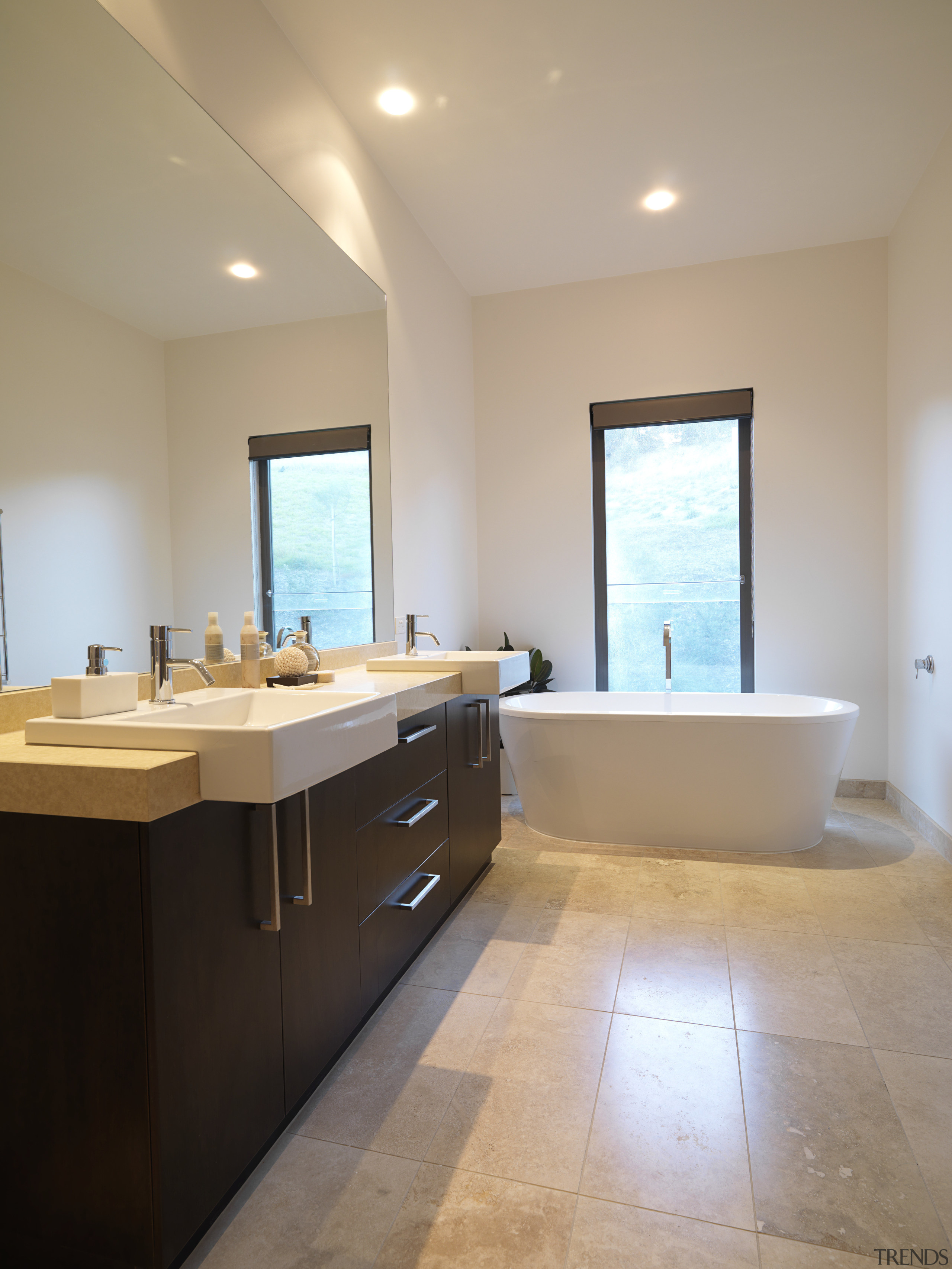 Bathroom, featuring vanity with dark-stained timber cabinetry and bathroom, daylighting, estate, floor, flooring, home, interior design, real estate, room, sink, gray