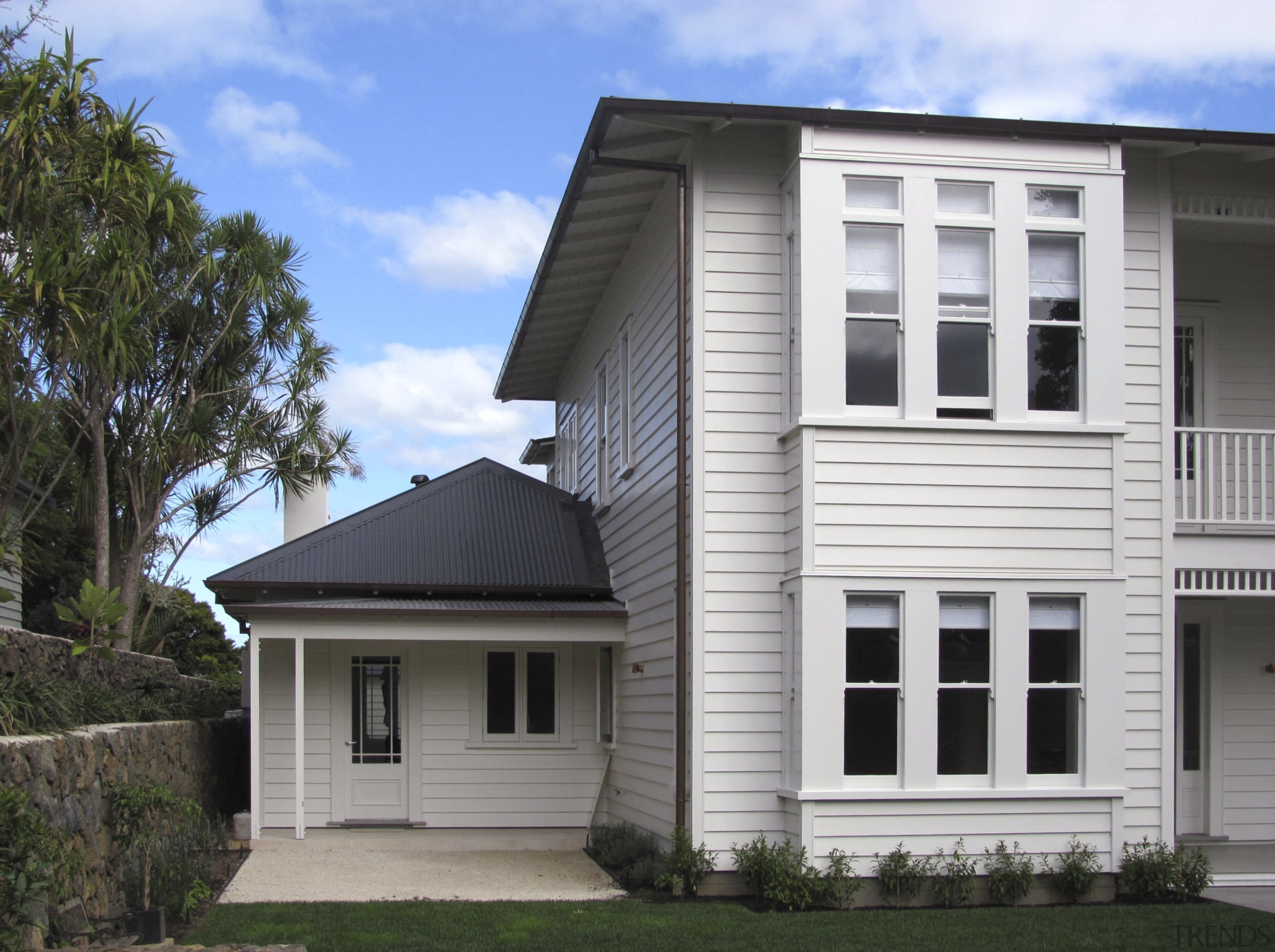 View of a renovated two-storey villa which features building, cottage, elevation, facade, home, house, property, real estate, residential area, roof, siding, window, white