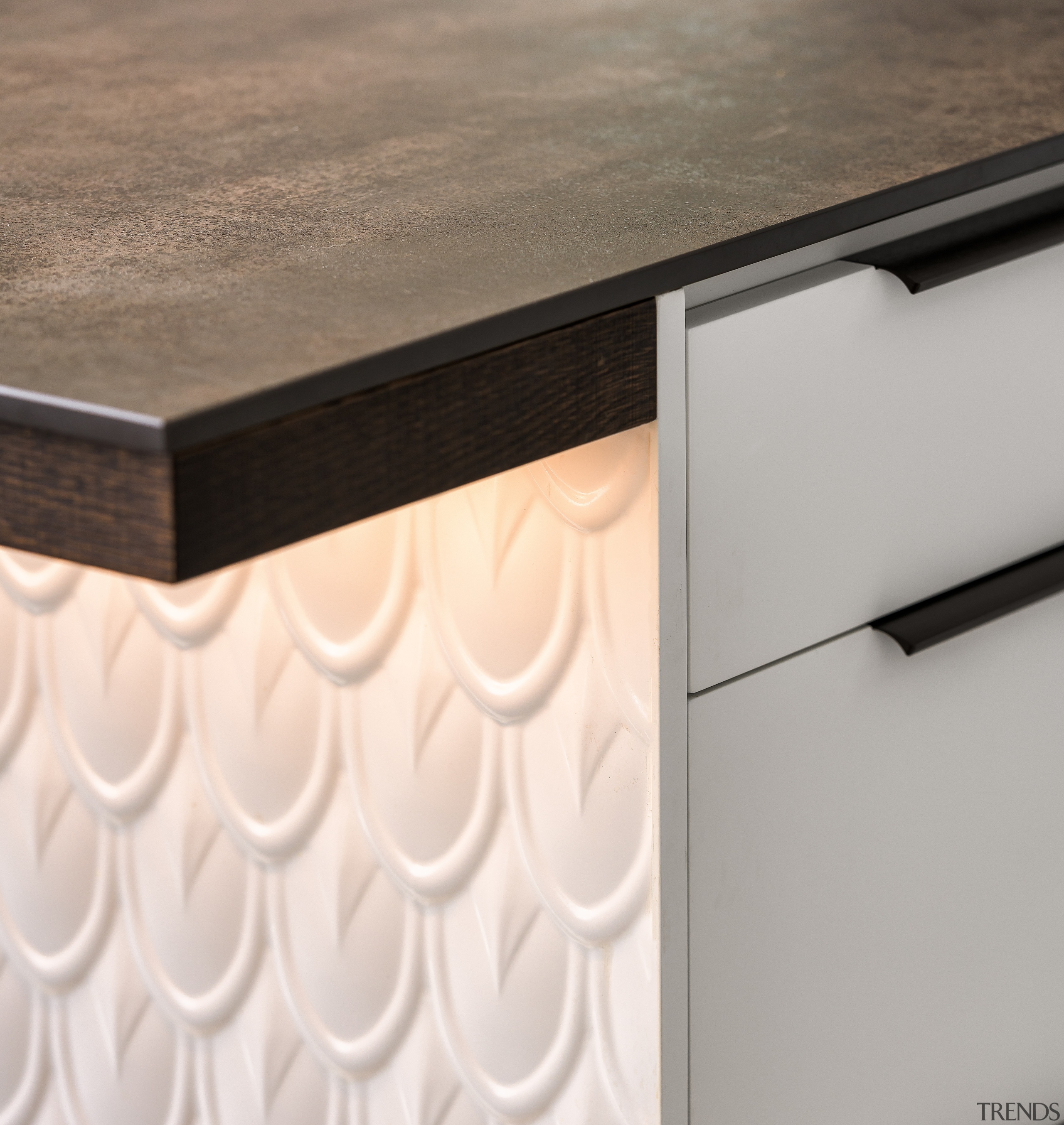 Porcelain benchtop meets powder-coated pressed tin. 