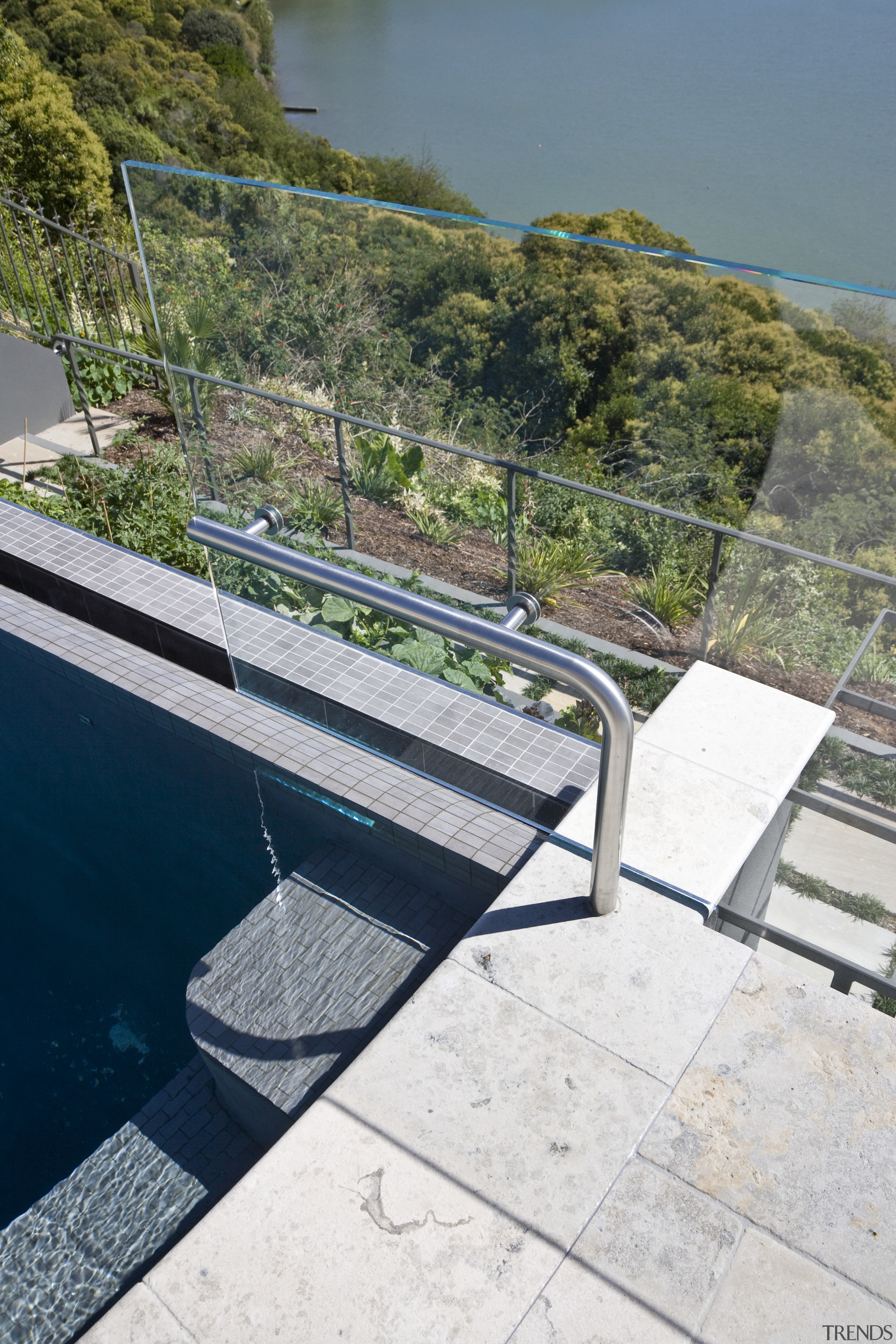 View of a curved glass balustrade from Glasshape. architecture, fixed link, outdoor furniture, sky, sunlounger, walkway, water, gray