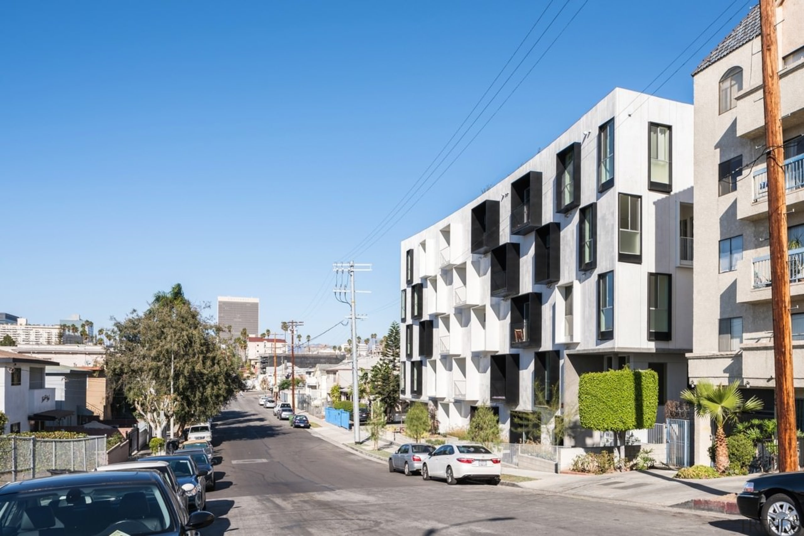 It's undeniably new – but it fits into apartment, architecture, building, city, condominium, daytime, downtown, facade, home, house, metropolis, metropolitan area, mixed use, neighbourhood, property, real estate, residential area, sky, street, suburb, tower block, town, urban area, urban design, teal