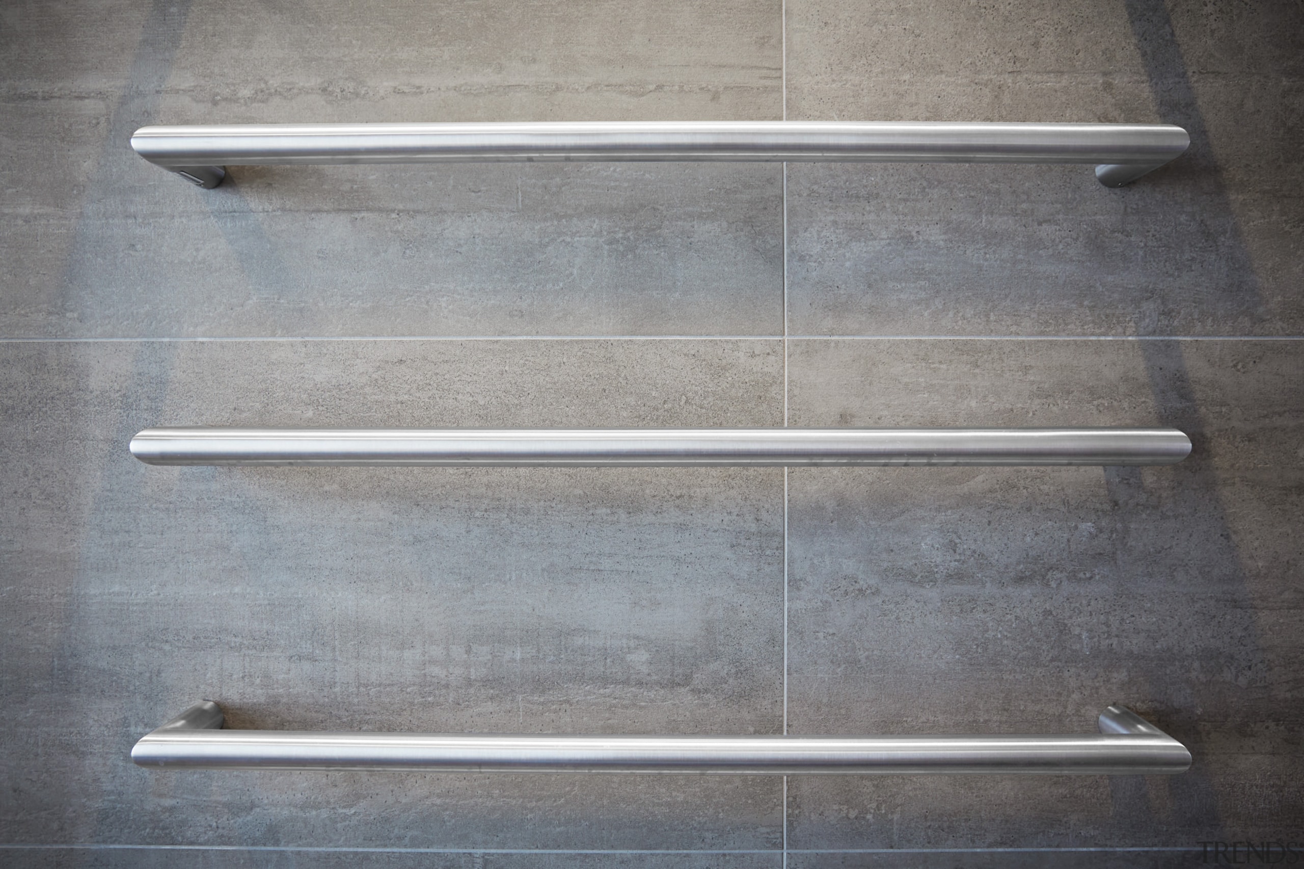 Heated towel rails provide an industrial touch in product design, steel, wood, gray