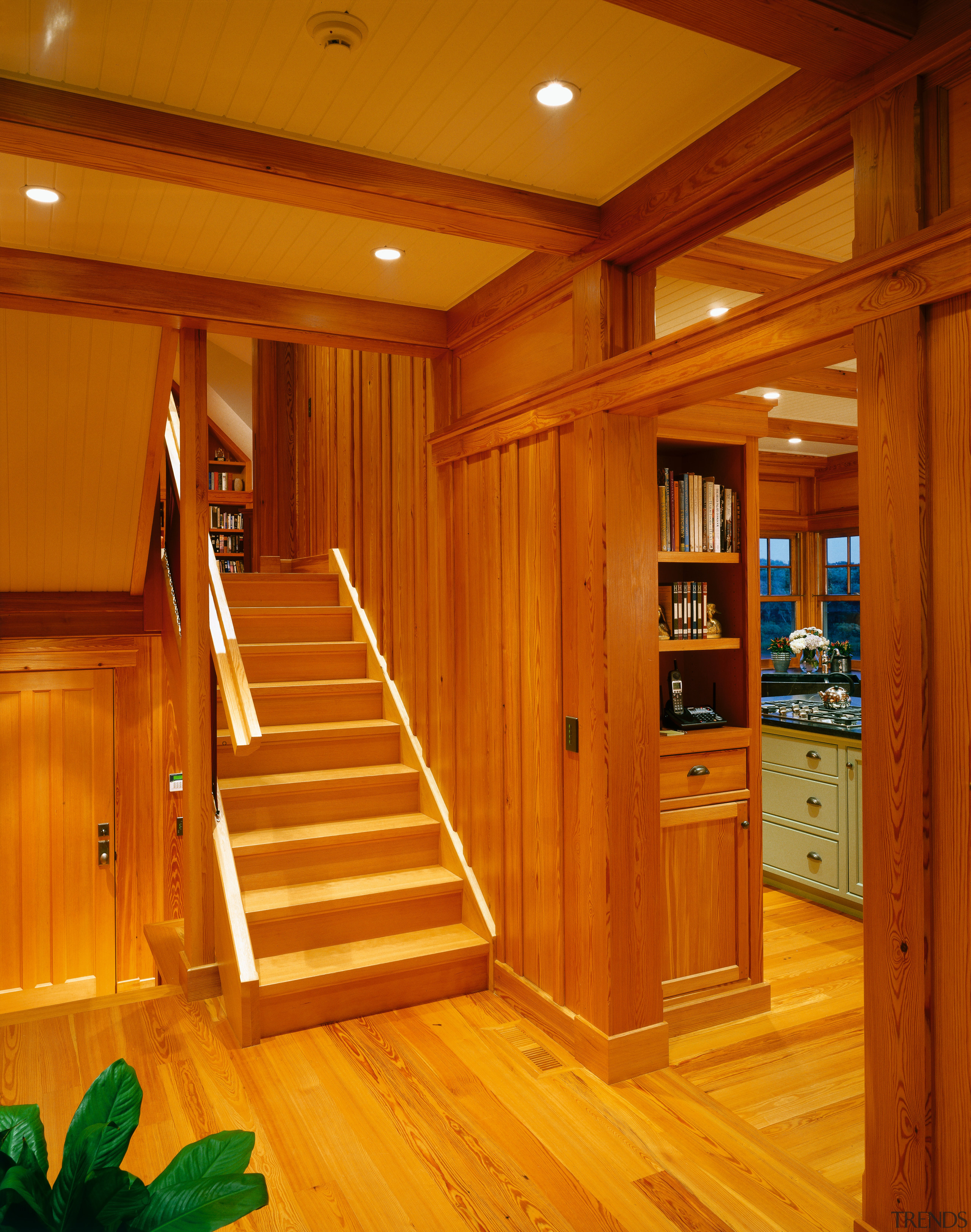 view of the stairway featuring timber flooring and cabinetry, ceiling, door, floor, flooring, hardwood, home, interior design, laminate flooring, lighting, lobby, real estate, stairs, wood, wood flooring, wood stain, brown, orange
