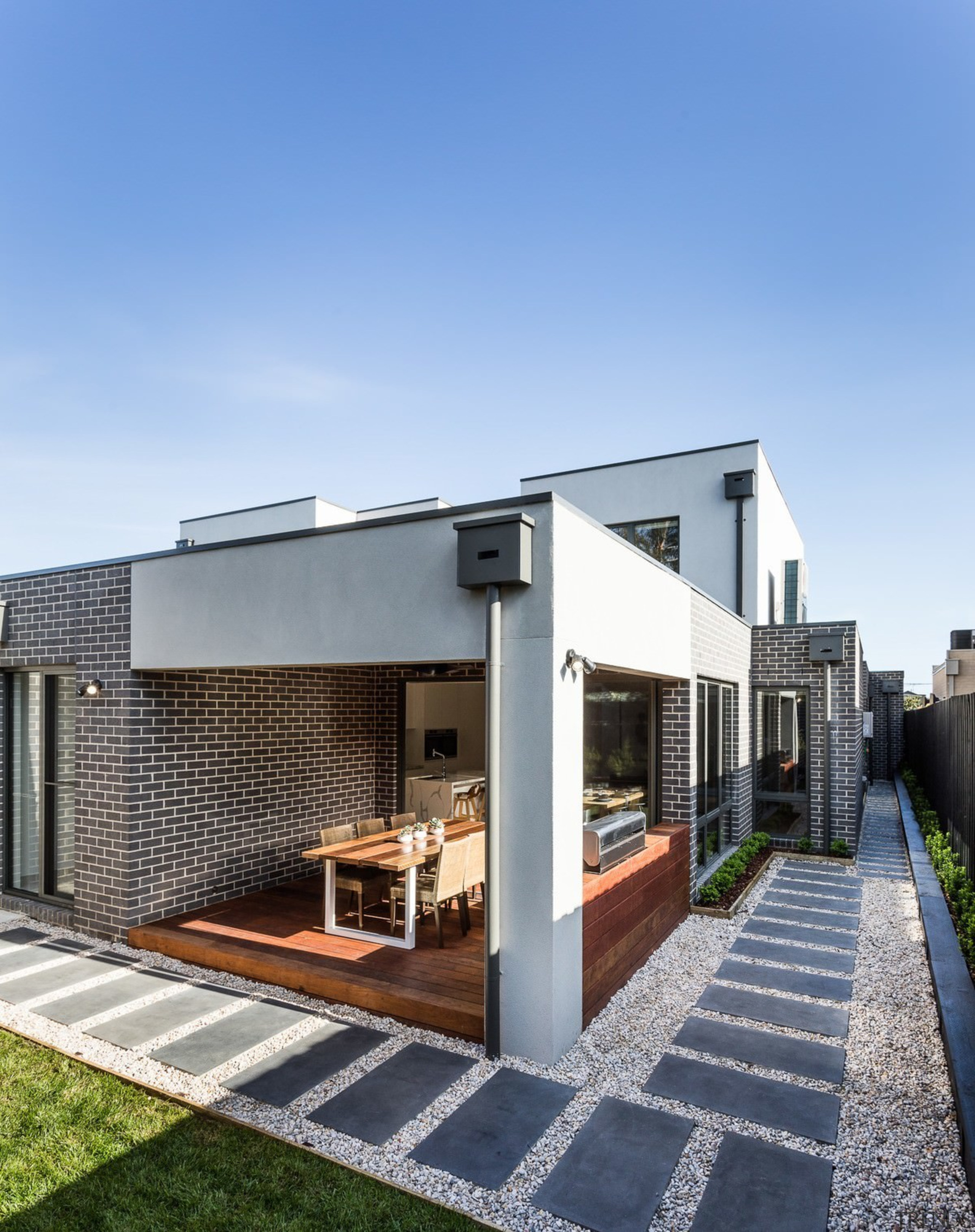 A pathway runs around the outside of the architecture, elevation, facade, home, house, property, real estate, residential area, teal