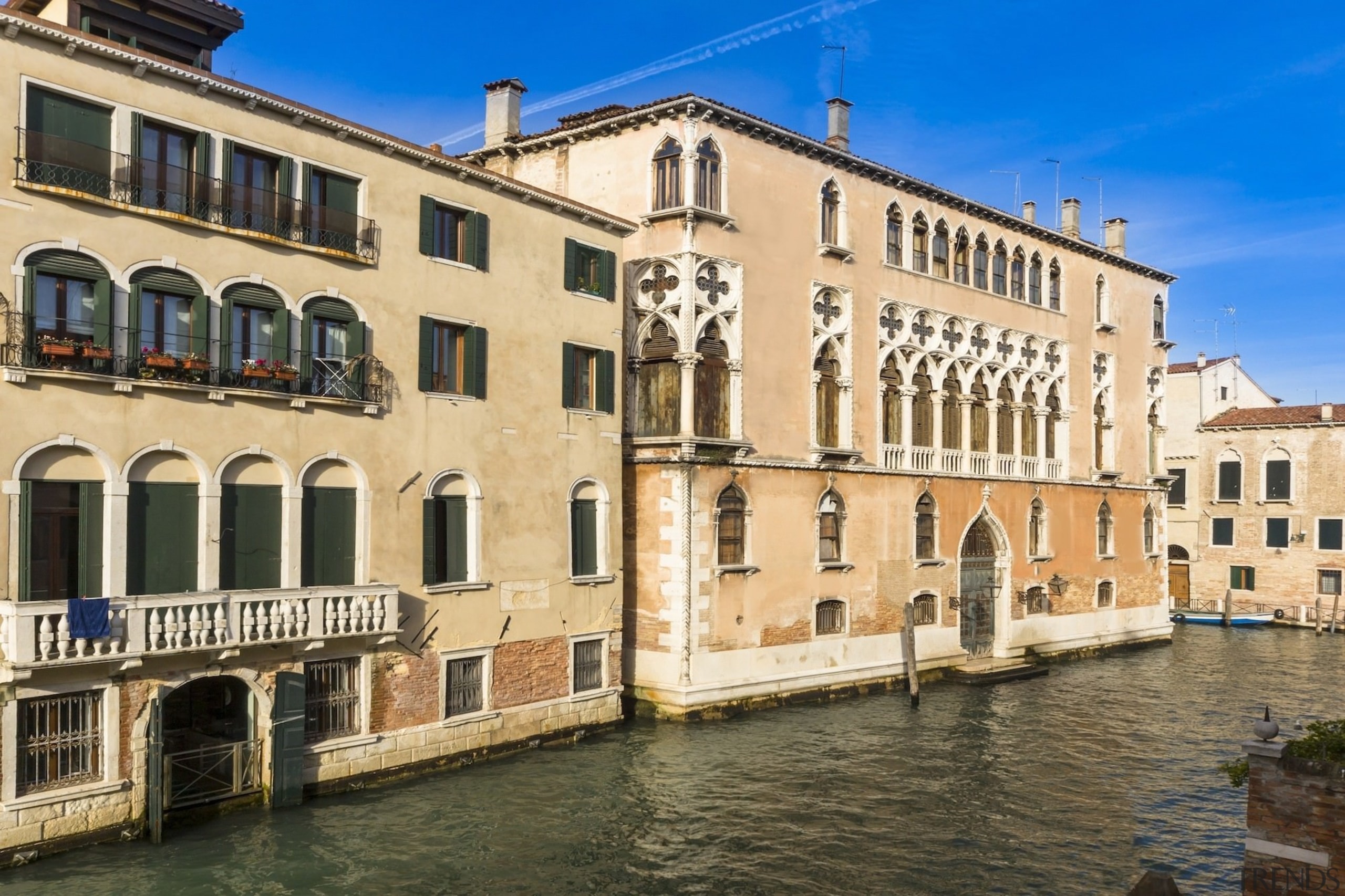 It's been owned by famous noble families from apartment, building, canal, channel, city, classical architecture, facade, historic site, medieval architecture, palace, plaza, property, real estate, town, waterway, window, orange, brown