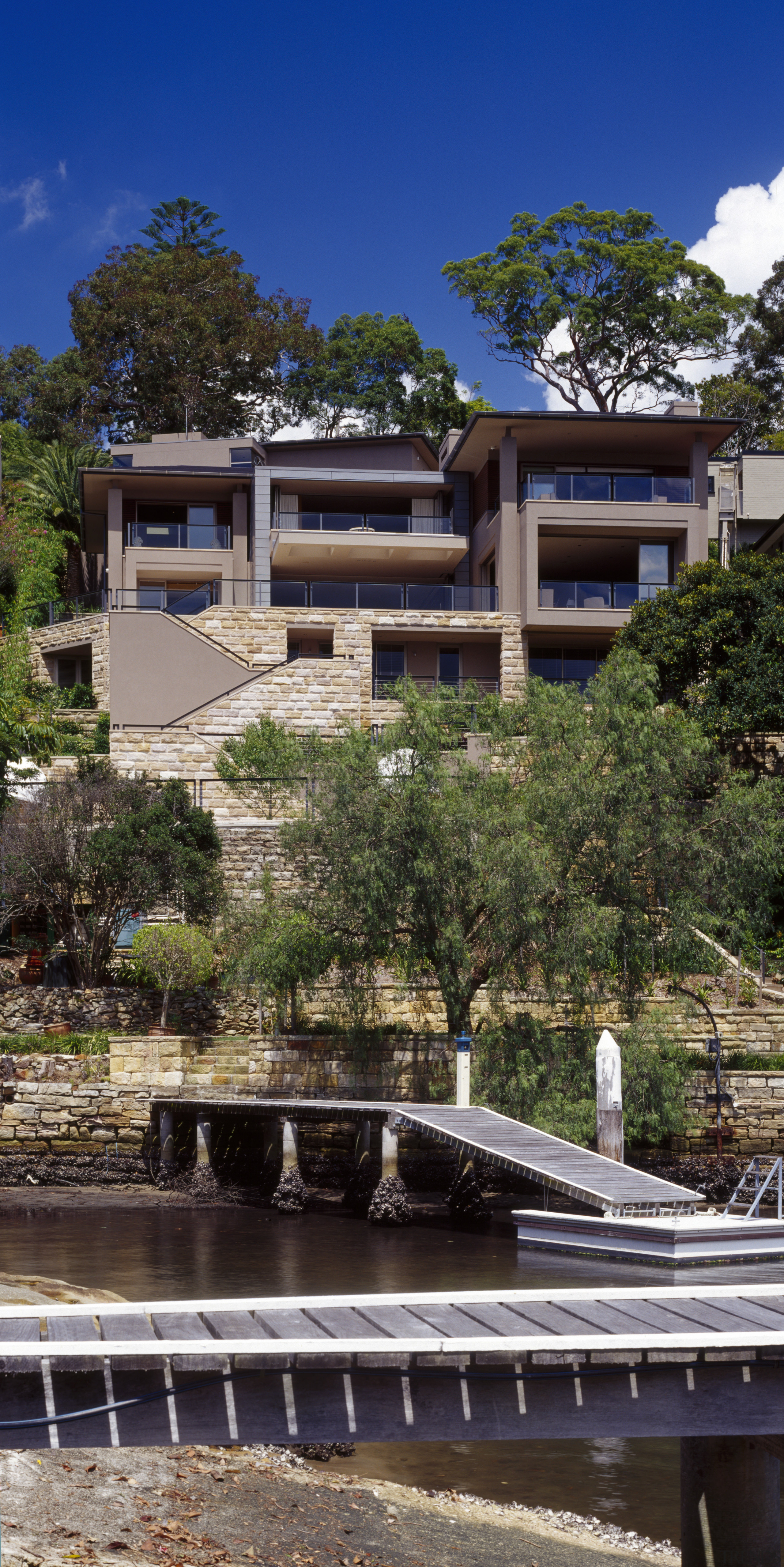 exterior view of house from the harbourside including architecture, building, home, house, plant, real estate, residential area, sky, tree, water