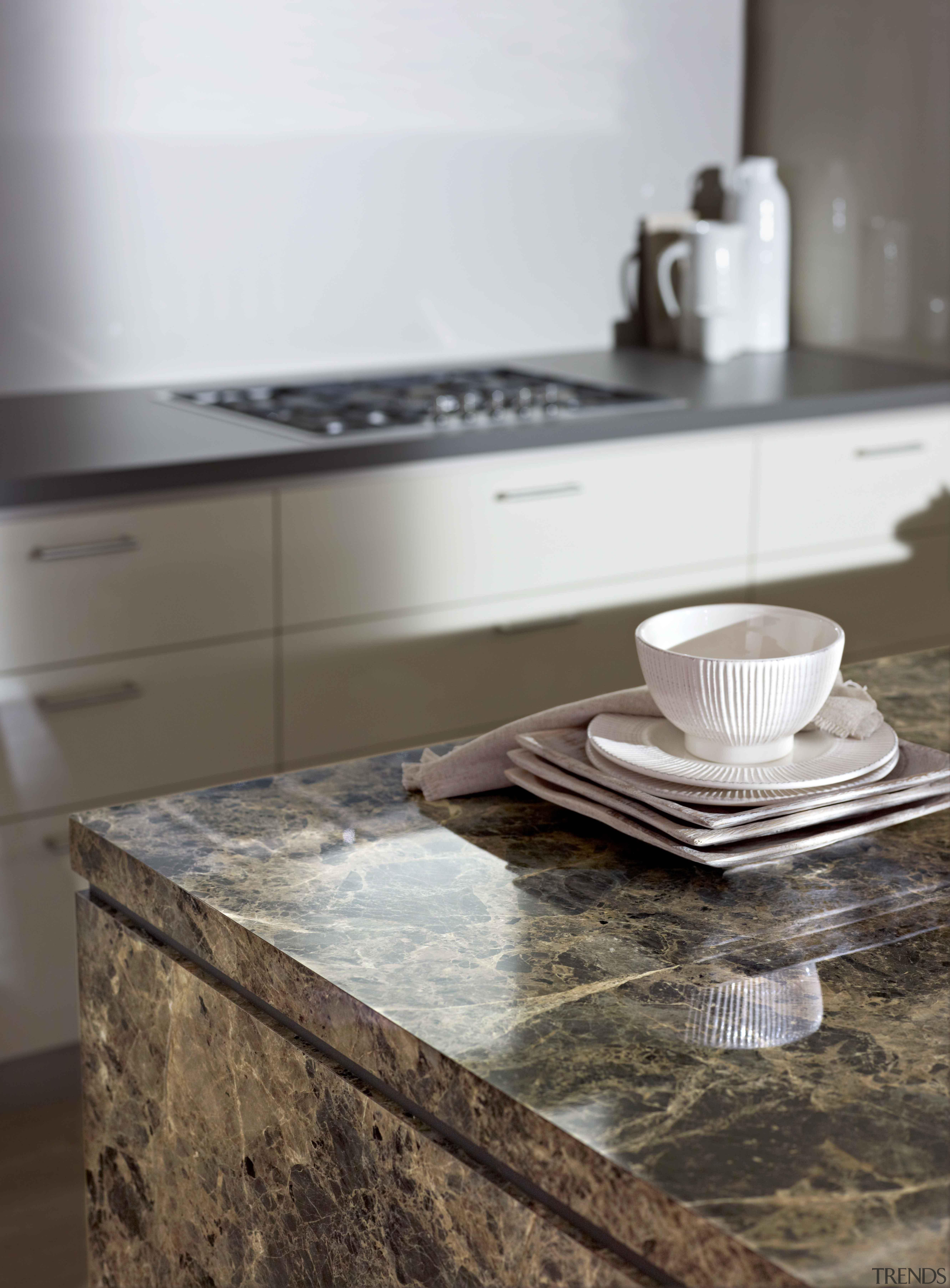 A striking marble pattern distinguished byfragments in varied countertop, floor, flooring, granite, kitchen, gray, white