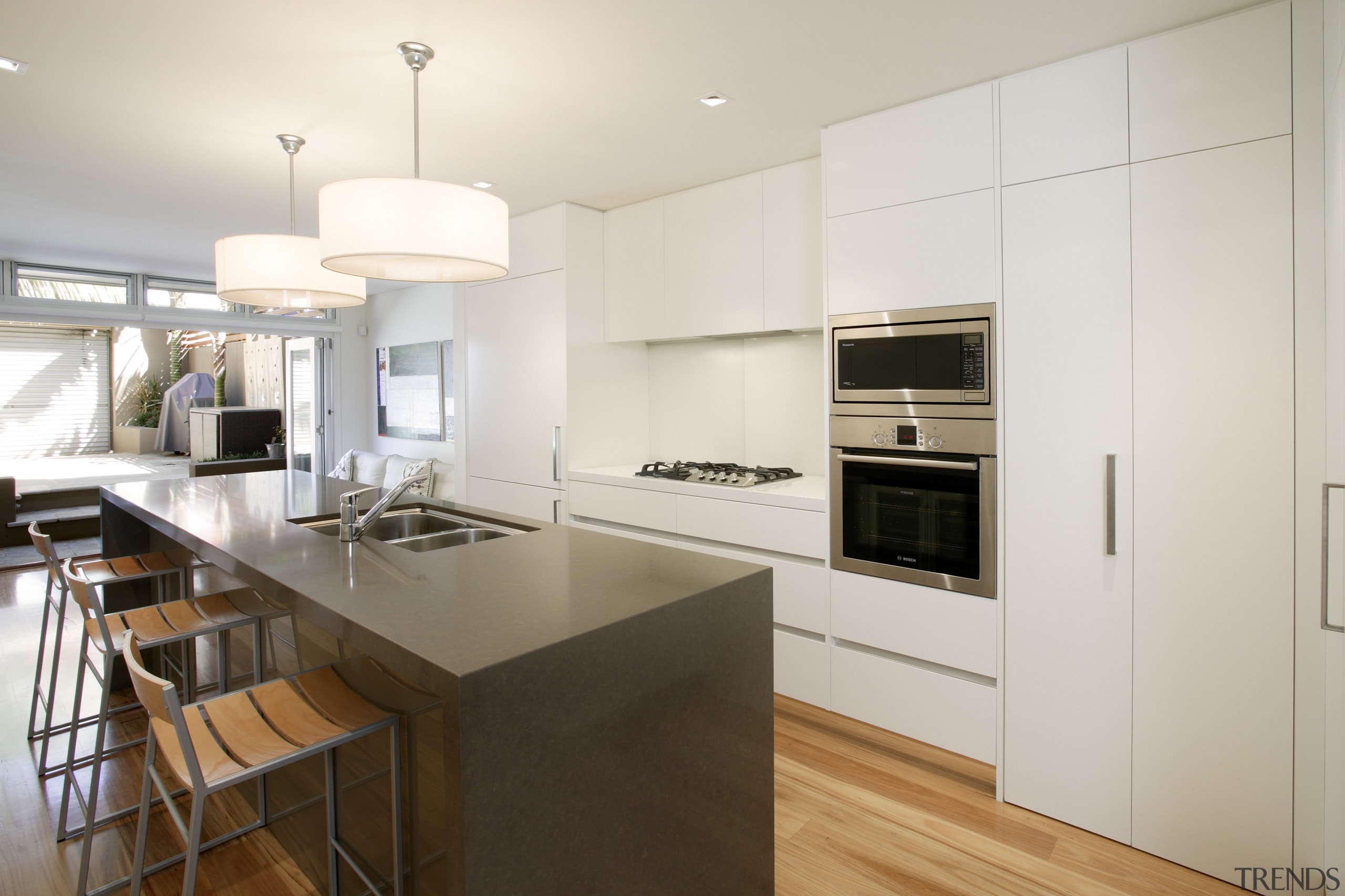 View of a narrow kitchen designed by Wonderful cabinetry, countertop, cuisine classique, floor, interior design, kitchen, real estate, wood flooring, white