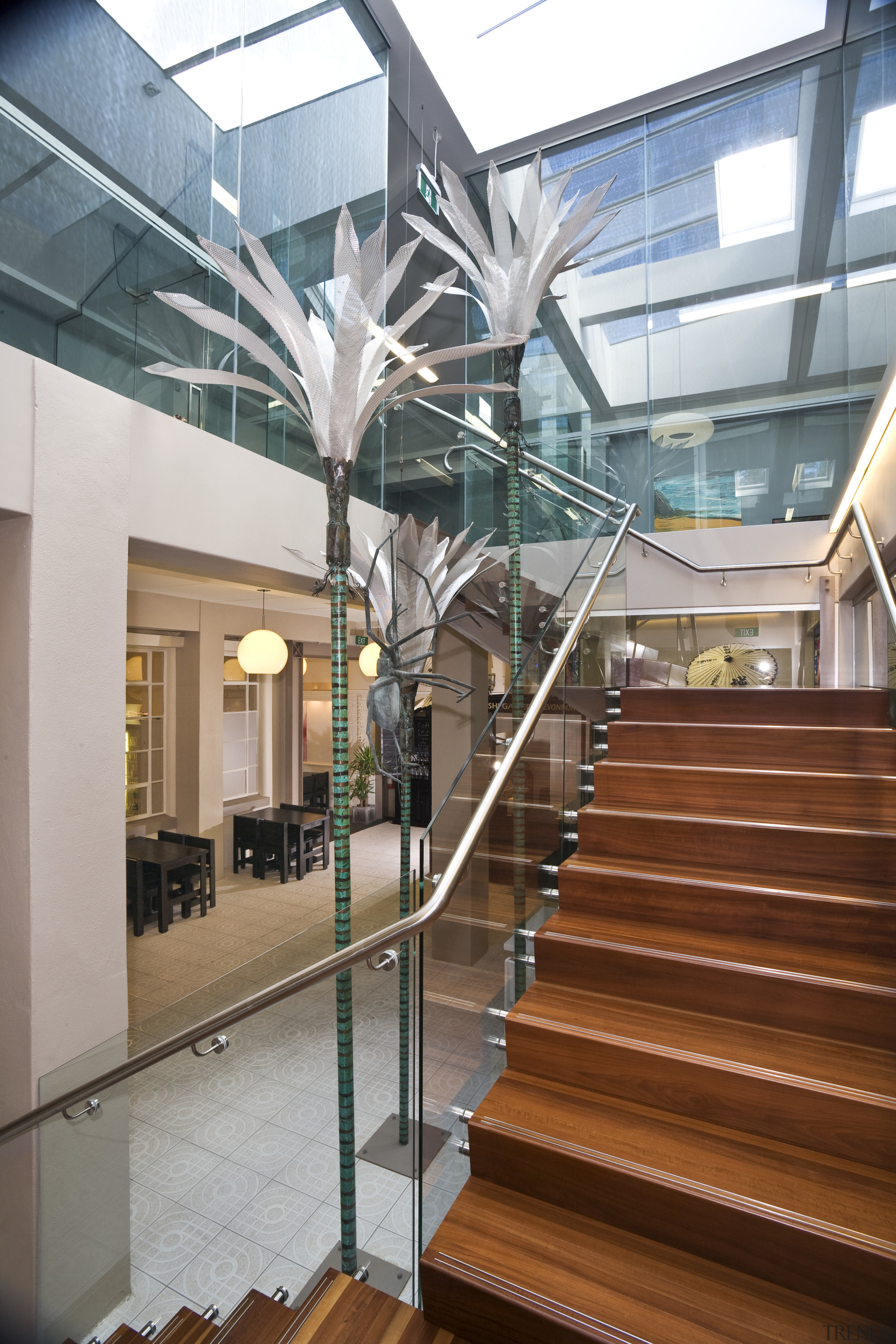 View of stairwell with glass balustrade, steel handrails, architecture, building, condominium, daylighting, glass, handrail, interior design, lobby, mixed use, real estate, stairs, structure, brown, gray