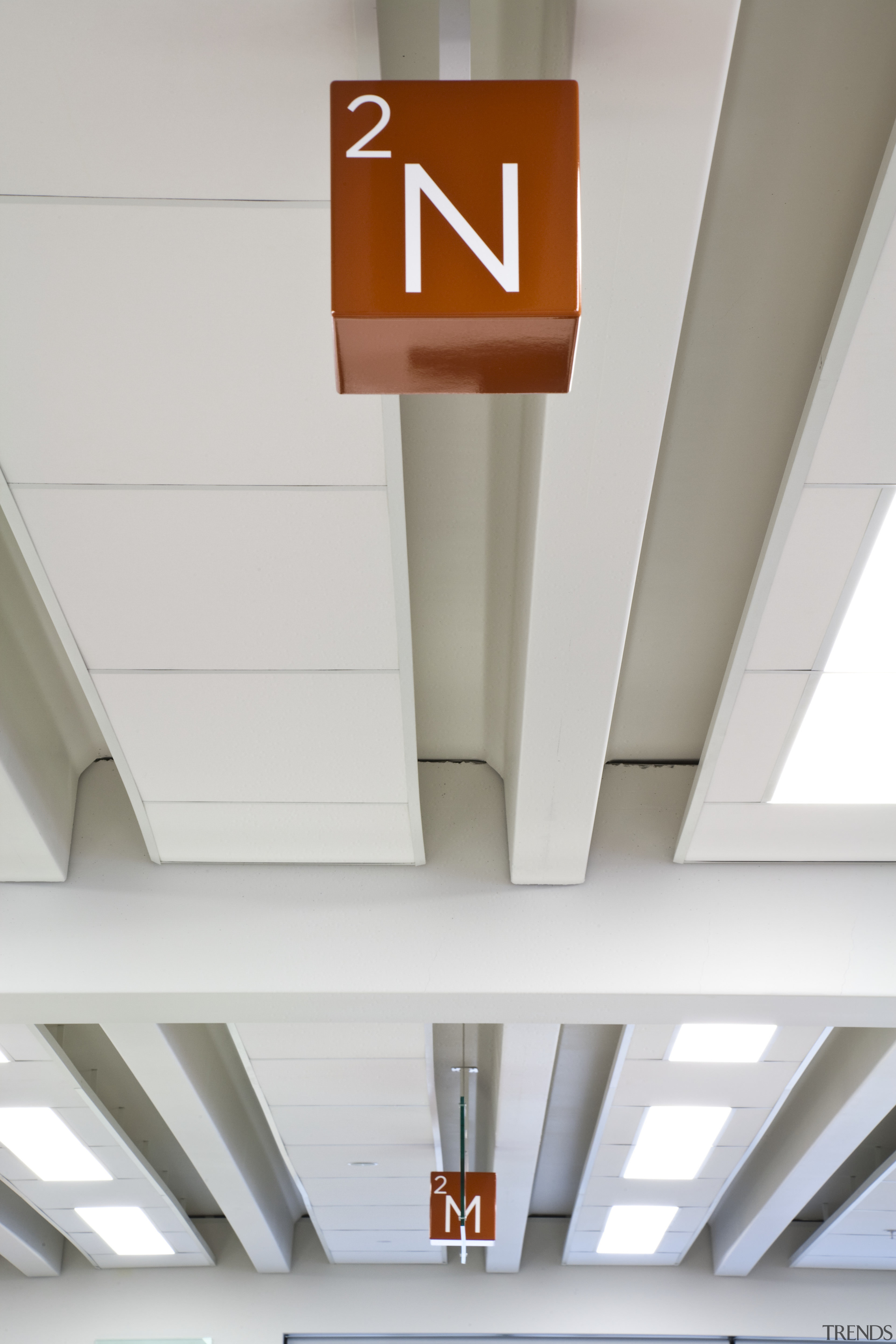 Rocket Signs developed and installed signage in the ceiling, daylighting, line, product design, white, gray