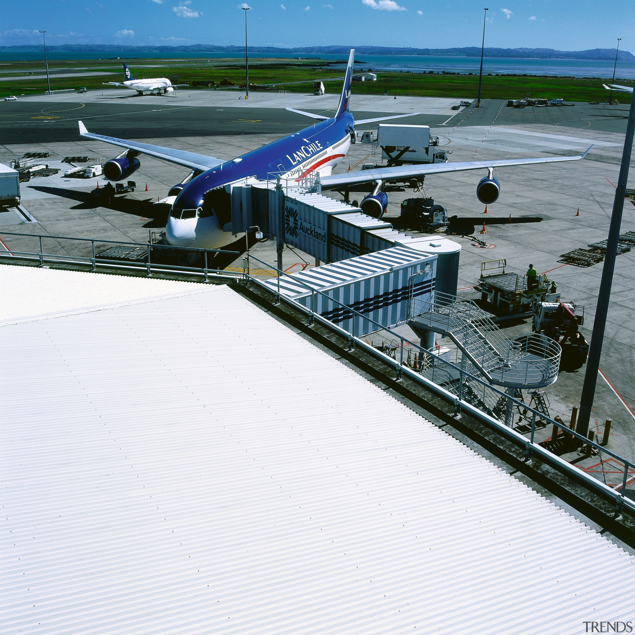 View of roof of airport building with walkway air travel, airplane, airport, airport apron, aviation, marina, roof, sky, water, white