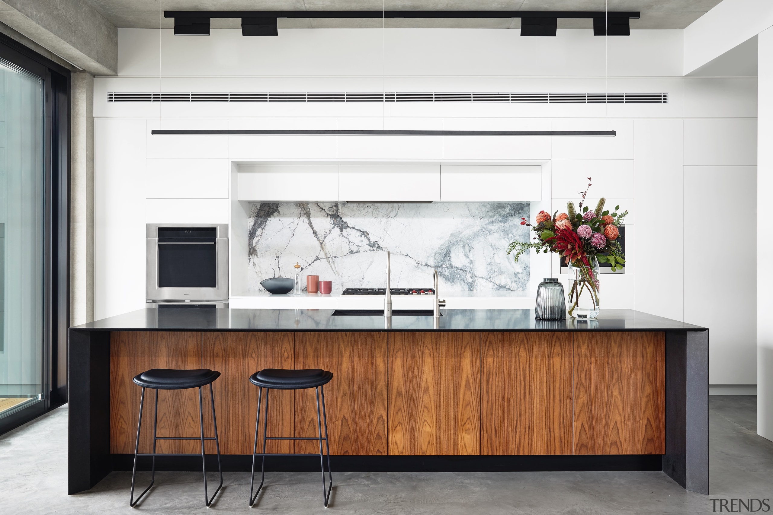 This open-plan kitchen reflects the owners' desire for building, cabinetry, chest of drawers, countertop, desk, furniture, home, house, interior design, kitchen, material property, property, room, table, white