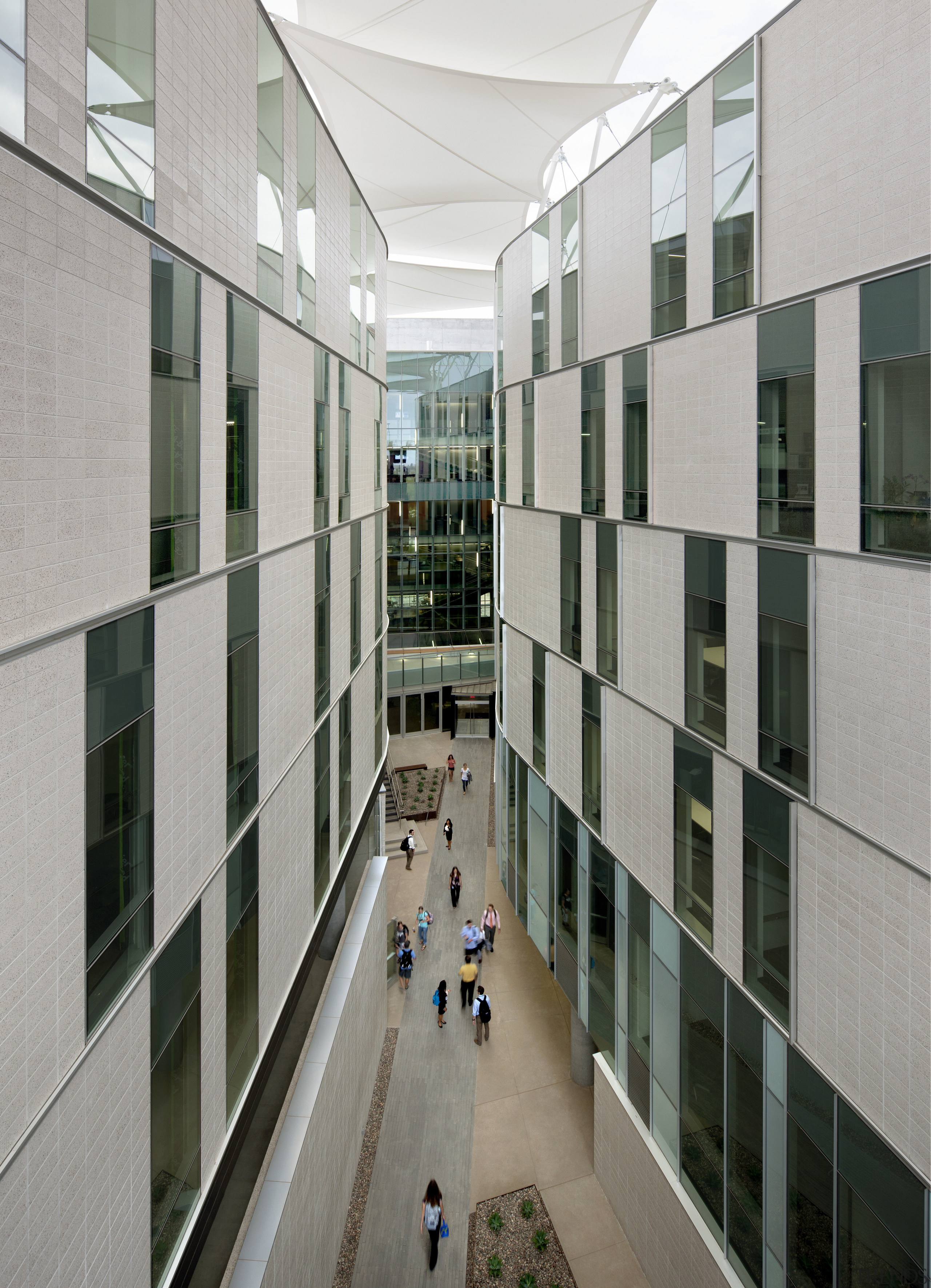 The canyon between the two wings of this apartment, architecture, building, commercial building, condominium, corporate headquarters, daylighting, facade, glass, headquarters, lobby, metropolitan area, mixed use, neighbourhood, residential area, tower block, window, gray