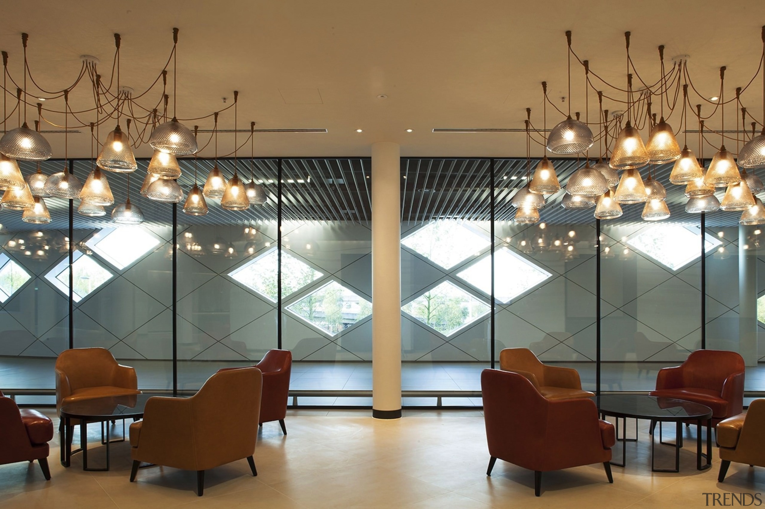 This light arrangement draws attention to the informal ceiling, furniture, interior design, light fixture, lighting, lobby, table, brown